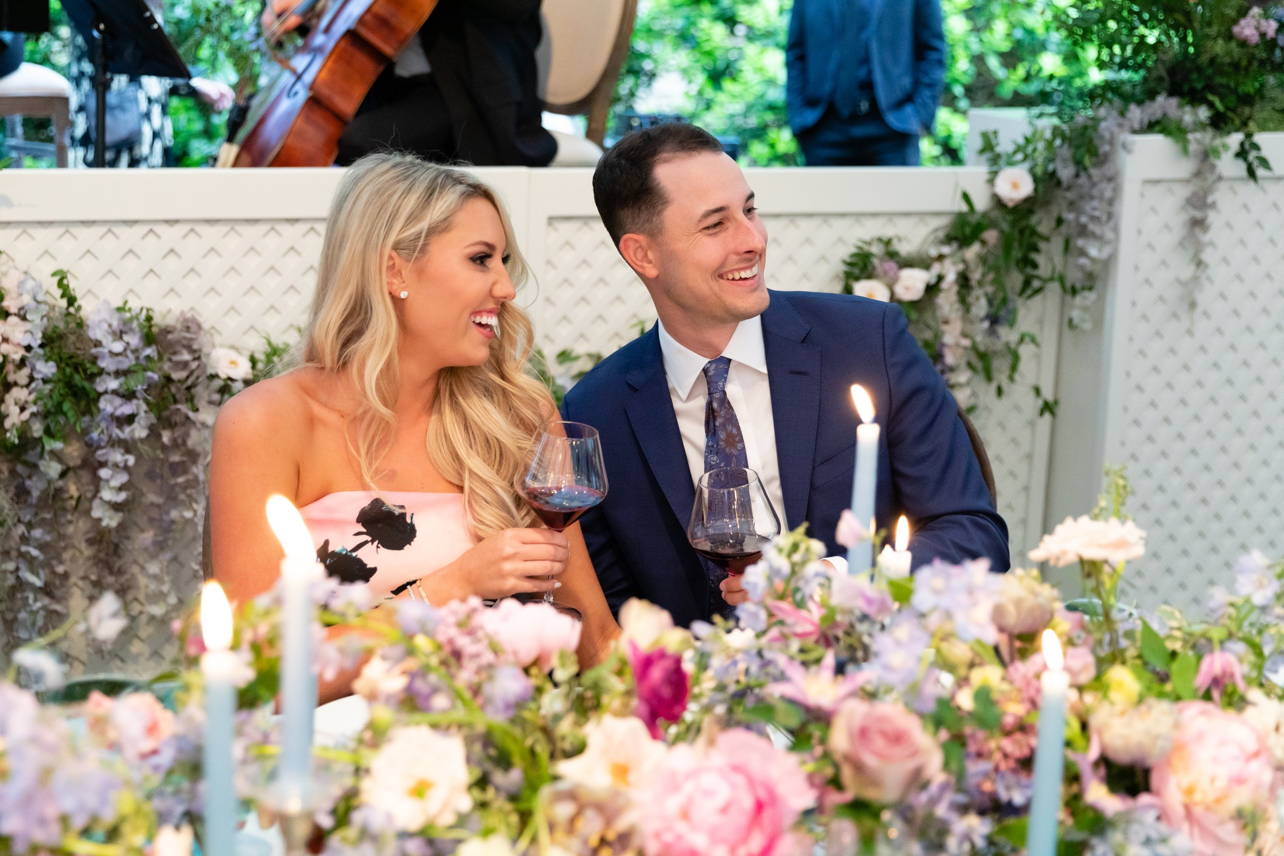 Growing, fresh floral centerpieces with blush garden roses, lilac, blue sweet peas, ranunculus, lavender delphinium, globe allium, clematis, and natural greenery for a tented Bridgerton inspired engagement party at a private home in Nashville, TN.
