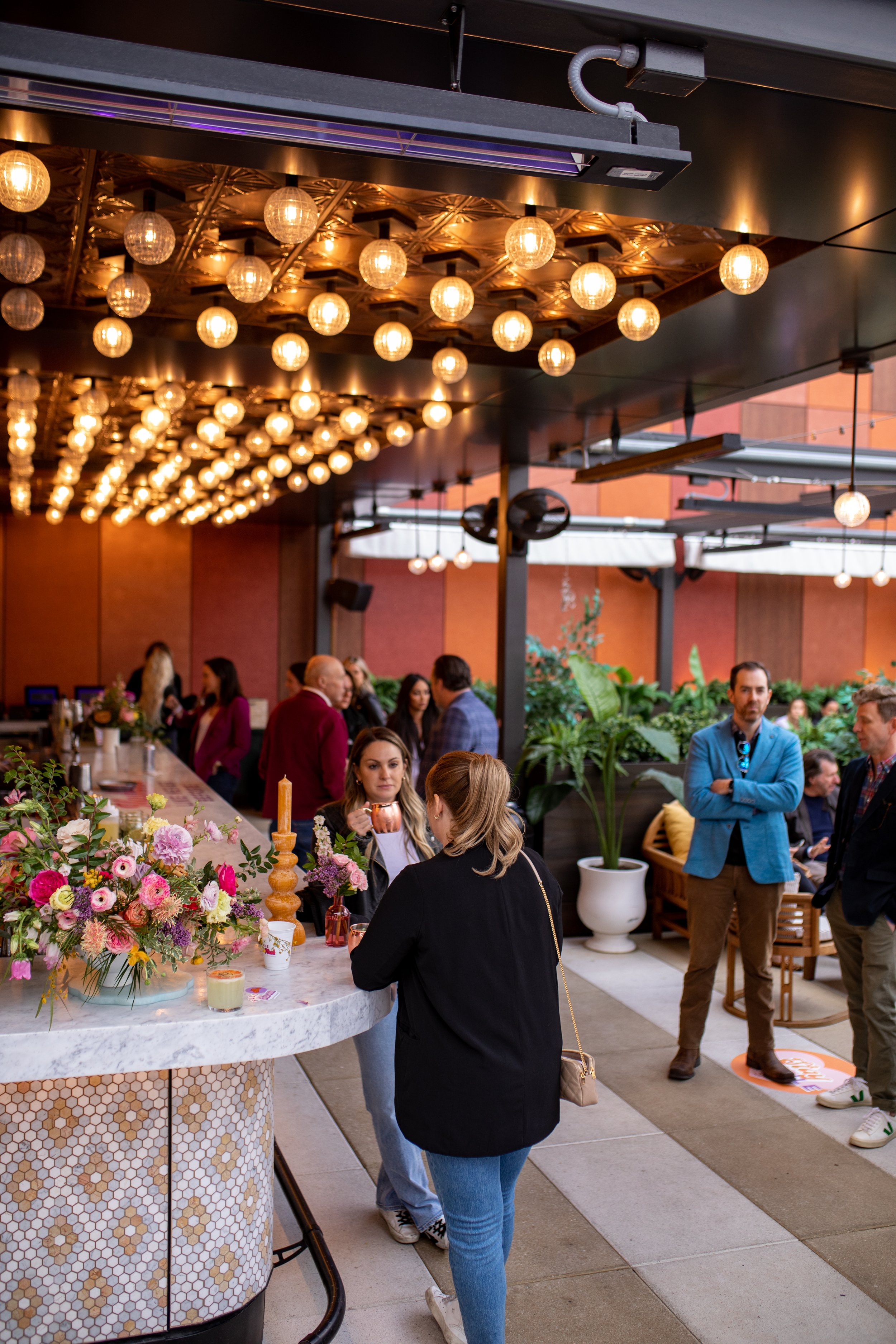 Bright spring floral hues of pink, lavender, coral, magenta, and yellow inspire the event space of Fifth + Broadway in Nashville, TN. Florals composed of roses, ranunculus, sweet peas, butterfly ranunculus, mixed greenery. Design by Rosemary and Finc