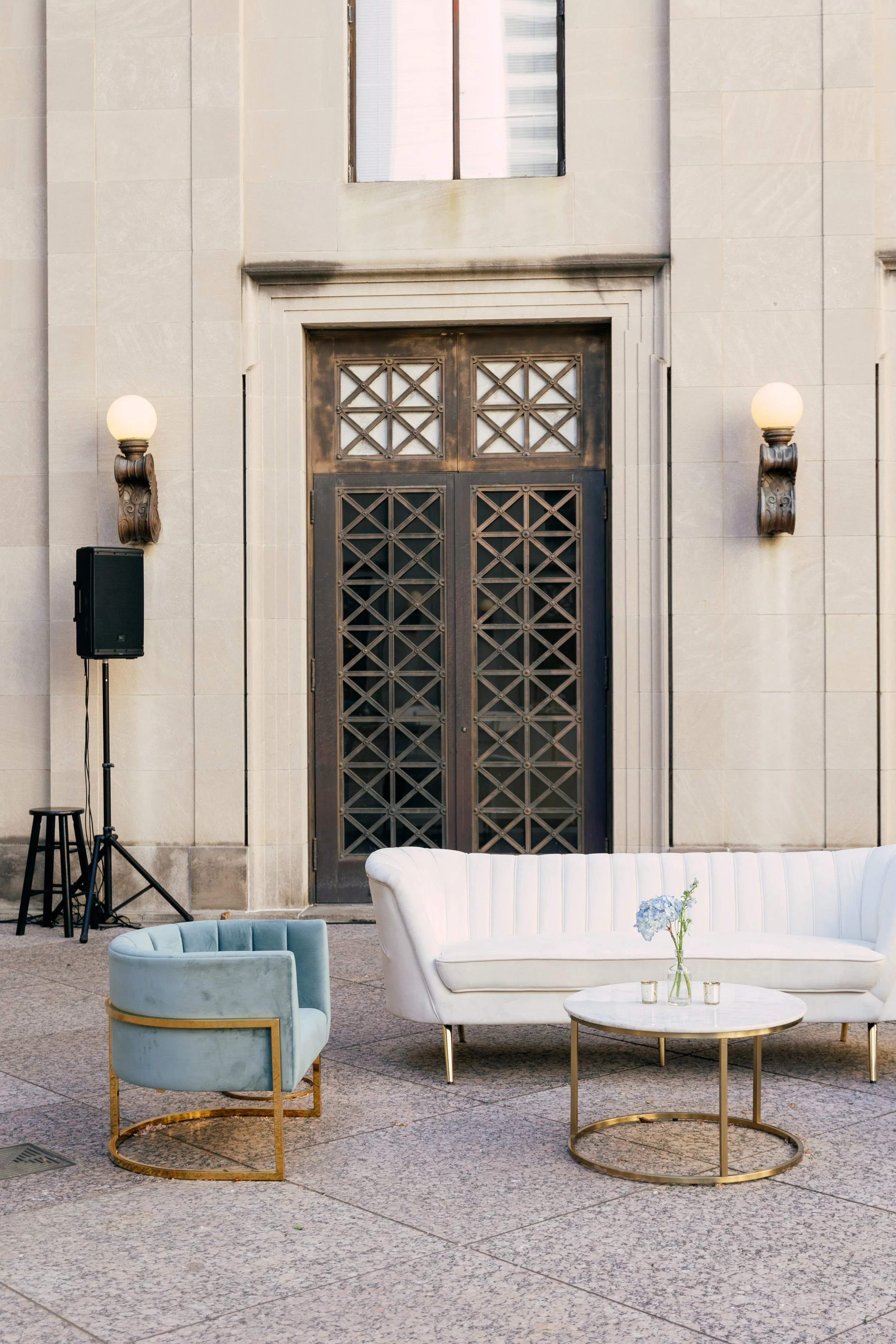 Bright dainty bud vases accent the welcome space of the War Memorial Auditorium in Nashville, TN. Following a color block theme comprised of hydrangeas, carnations, roses, and pampas grass. TPAC Gala designed by Rosemary and Finch.
