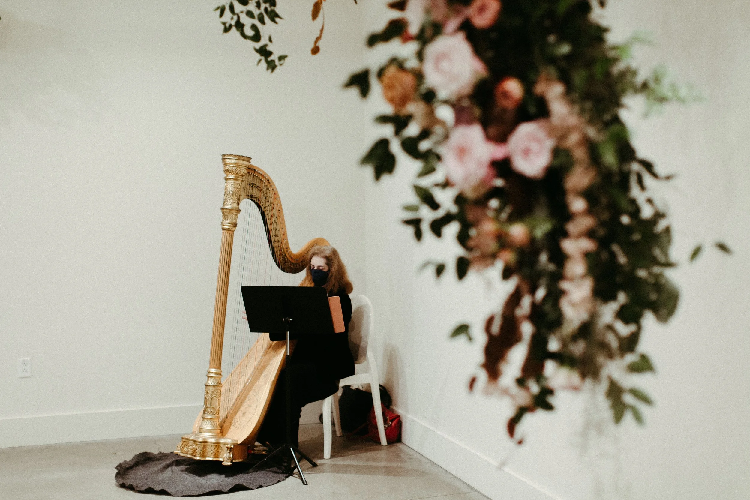 An eye-catching whimsical installation full of petal heavy roses and copper beech was the highlight of this art deco wedding. Terra cotta, burgundy, dusty pink, and other neutral florals warm up this ceremony. Designed by Rosemary and Finch in Nashvi