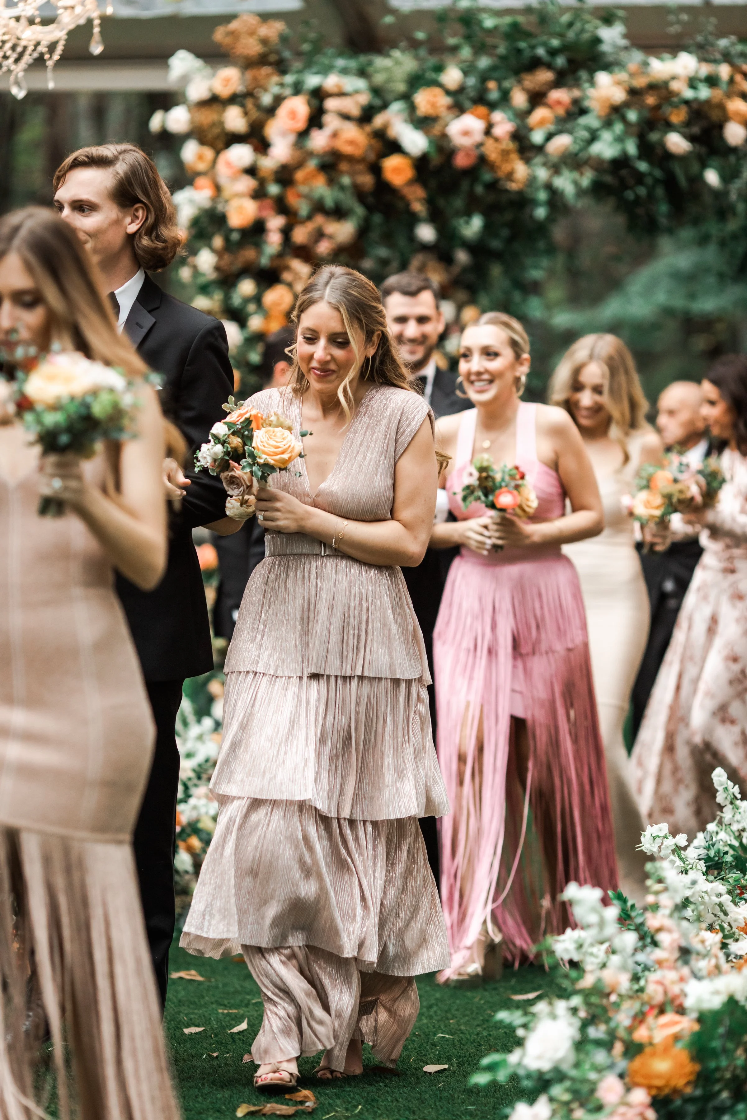 An elegant fall bridal bouquet featuring a sunset color palette of blush, terra cotta, rose gold, yellow, and copper. Florals accents of dahlias, garden roses, ranunculus, and double brownie tulips. Designed by Rosemary and Finch in Nashville, TN.