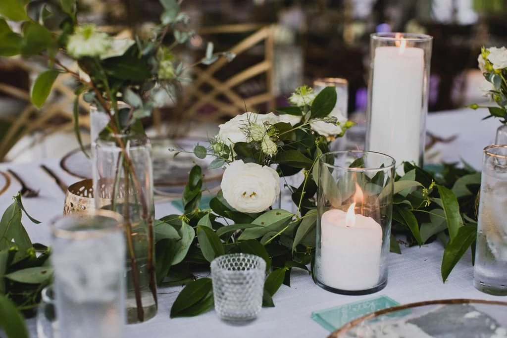 This backyard reception had a lush head table filled with garlands of eucalyptus, garden roses, ruscus, and spray roses. Designed by Rosemary and Finch in Nashville, TN.
