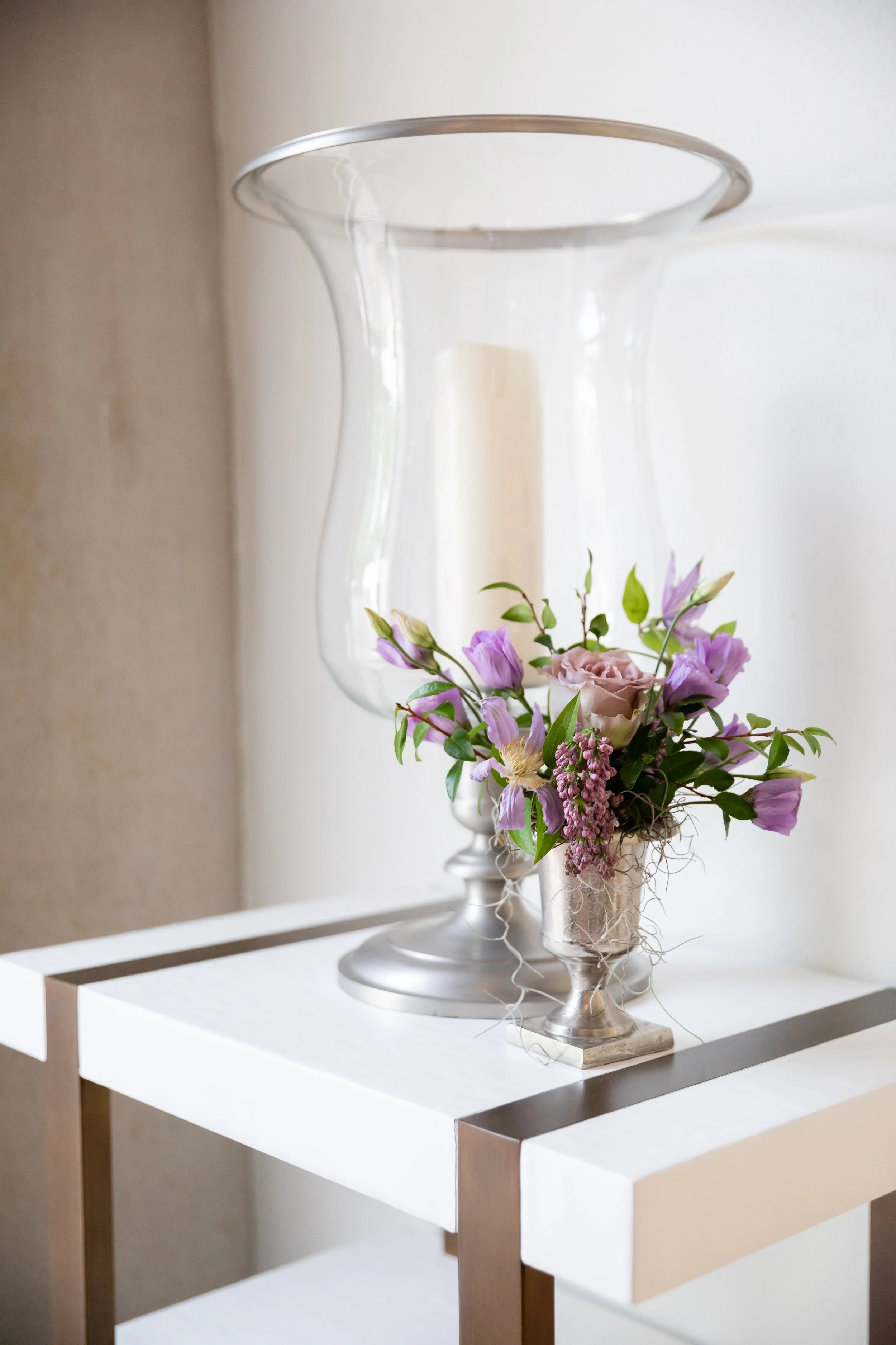 Bridgerton inspired engagement party at a private home in Nashville, TN with color blocked flower arrangements in shades of pink, blue, and lavender with matching votives candles. Natural greenery, garden roses, ranunculus, and wildflowers. Nashville