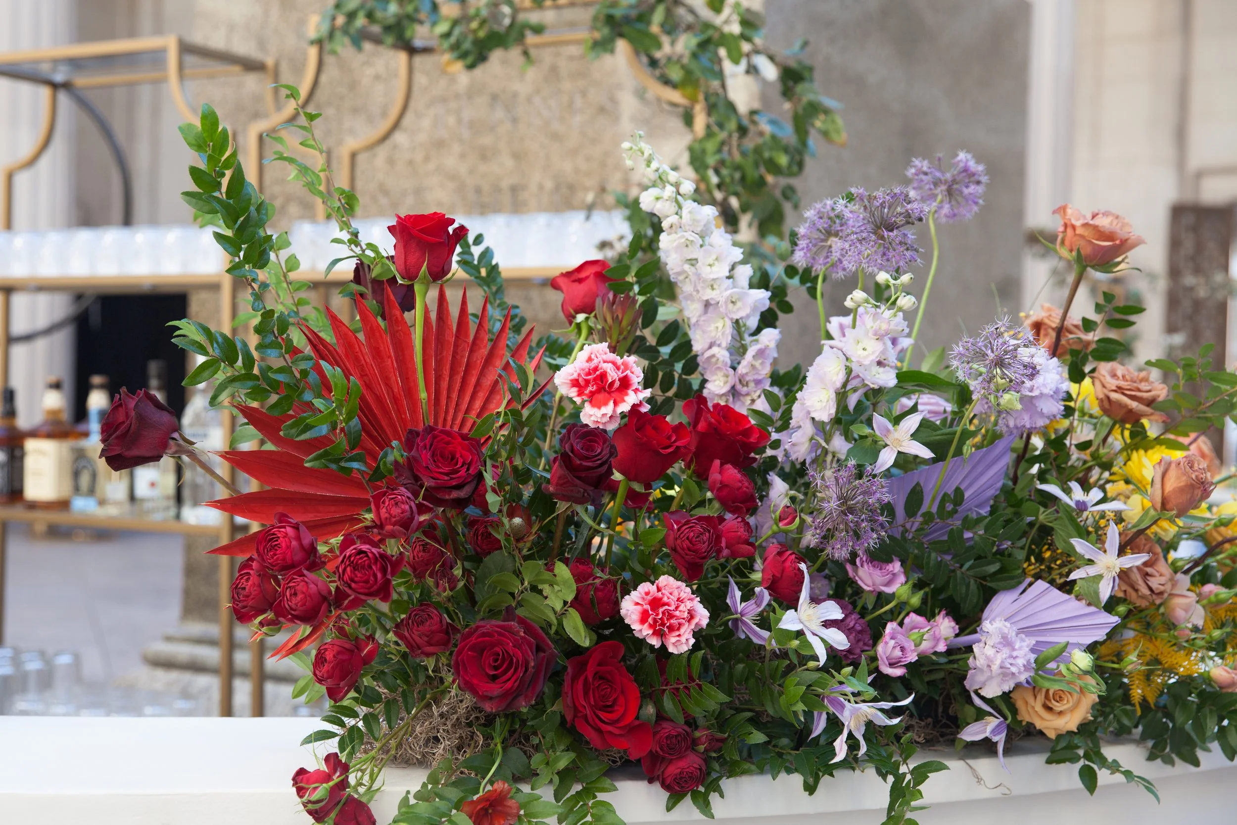 Bright and colorful arrangements create an inviting scene for guests at the TPAC Gala in Nashville Tennessee. Florals composed of roses, hydrangeas, tulips, snapdragons, dried palm, and anthurium. Designed by Rosemary and Finch.