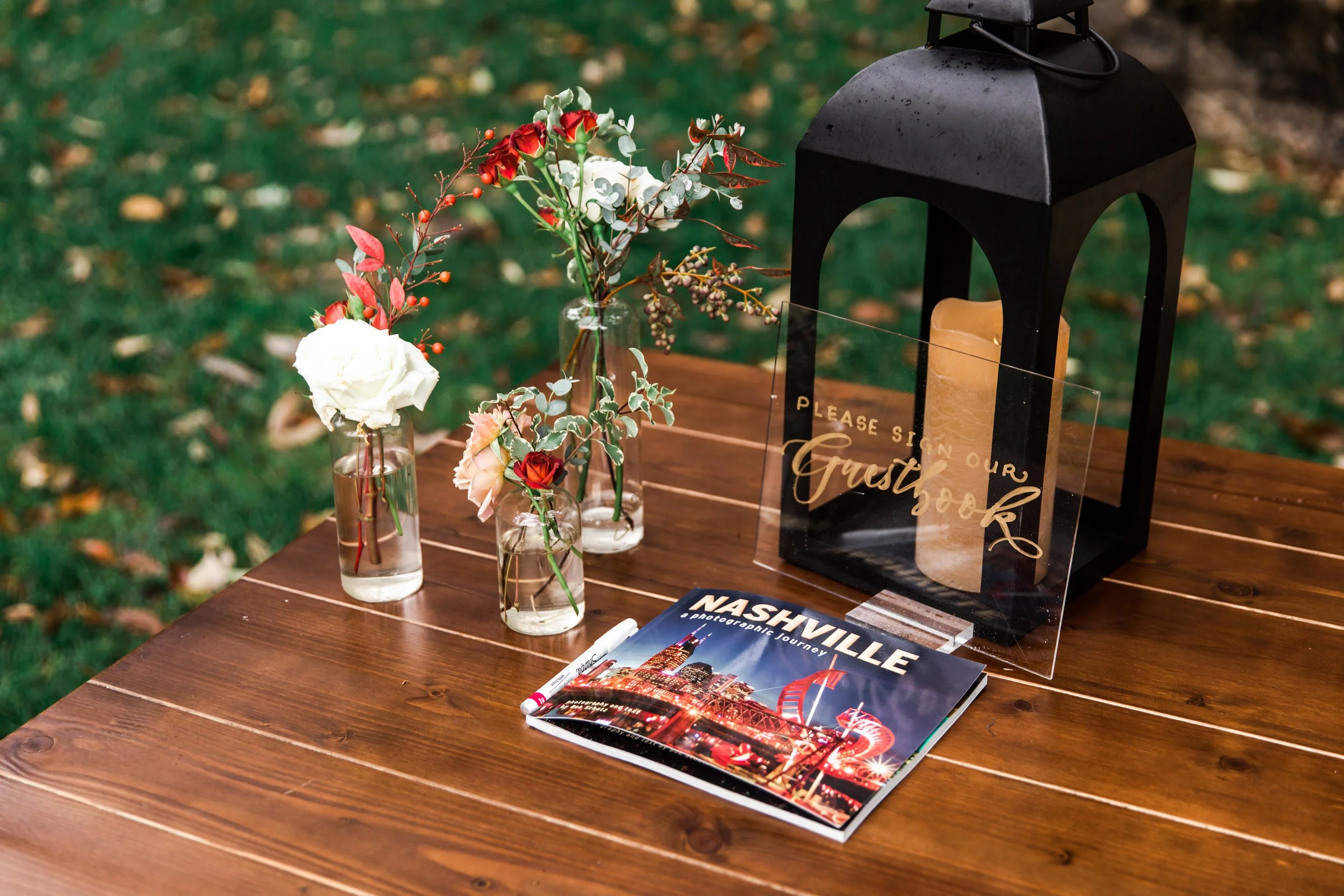Elegant accents of fall florals, including roses, dahlias, and fall greenery, decorate the reception space of this autumnal wedding. Hues of terra cotta, rose gold, yellow, copper, and dusty pink. Designed by Rosemary and Finch in Nashville, TN.