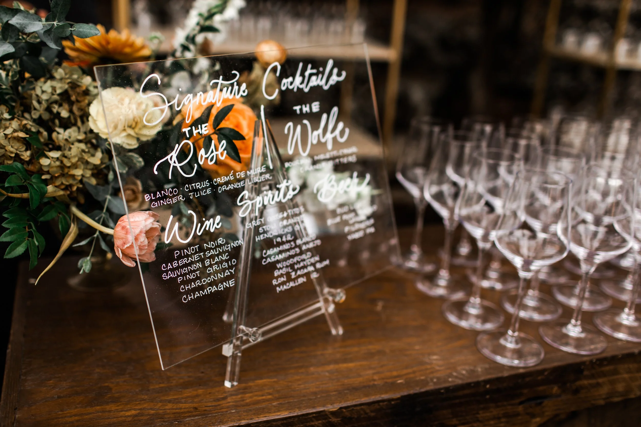 Elegant accents of fall florals, including roses, dahlias, and fall greenery, decorate the reception space of this autumnal wedding. Hues of terra cotta, rose gold, yellow, copper, and dusty pink. Designed by Rosemary and Finch in Nashville, TN.