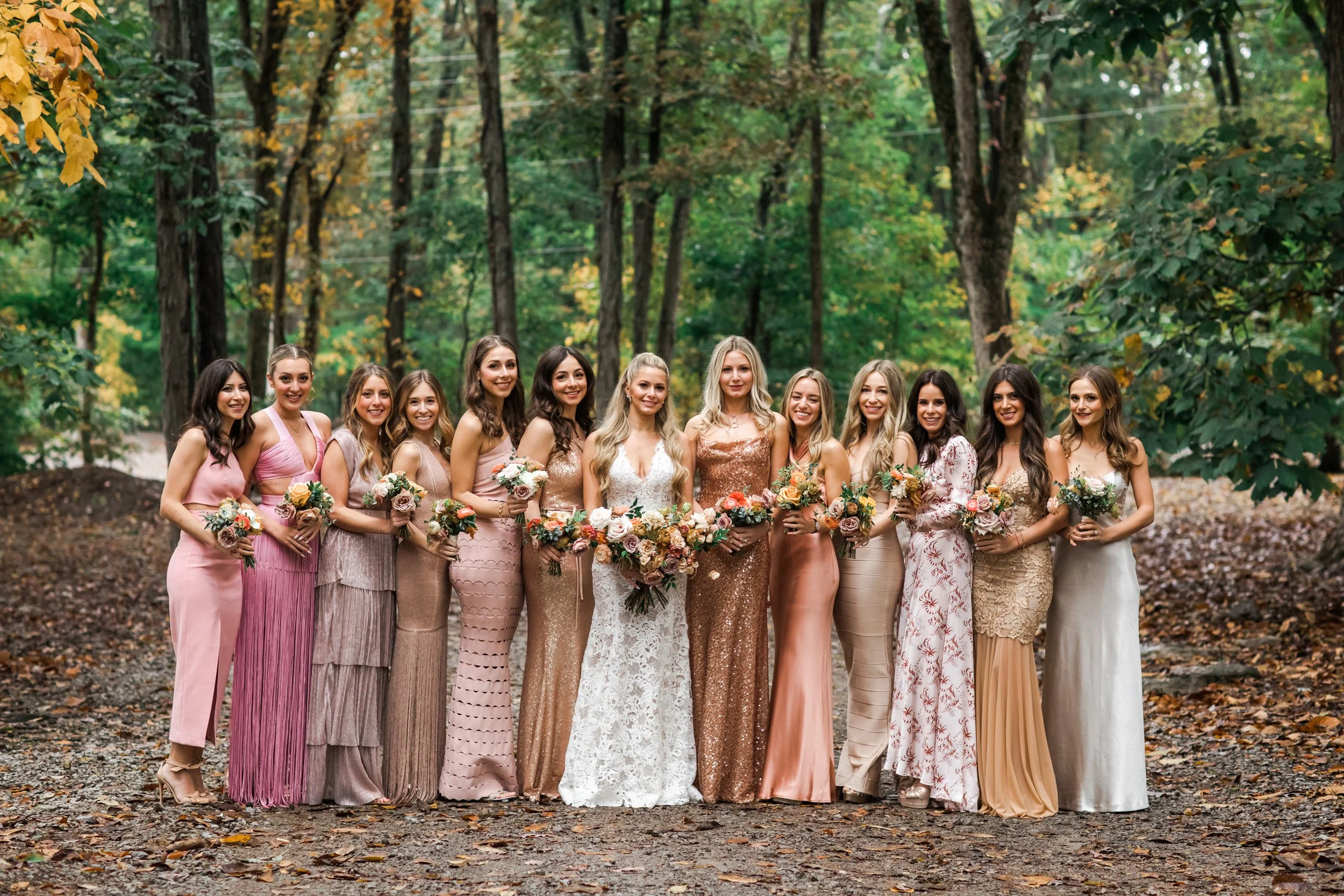 An elegant fall bridal bouquet featuring a sunset color palette of blush, terra cotta, rose gold, yellow, and copper. Florals accents of dahlias, garden roses, ranunculus, and double brownie tulips. Designed by Rosemary and Finch in Nashville, TN.