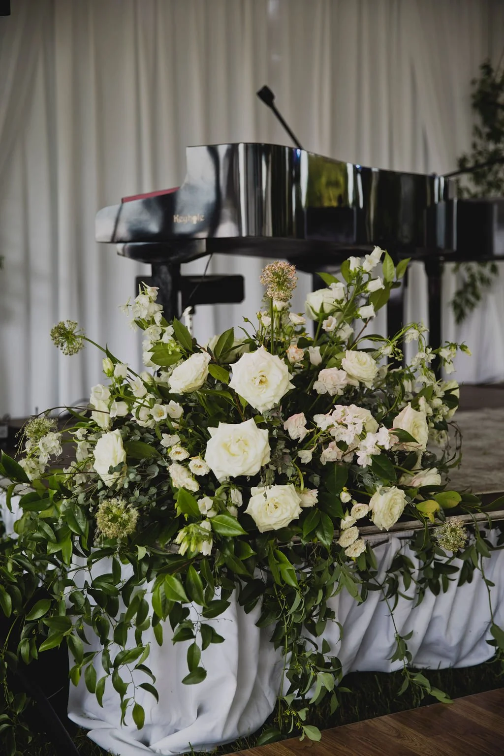 The centerpieces at this romantic summer wedding are filled with white ranunculus, garden roses, spray roses, delphinium, queen anne's lace, and lush greenery. Designed by Rosemary and Finch in Nashville, TN.