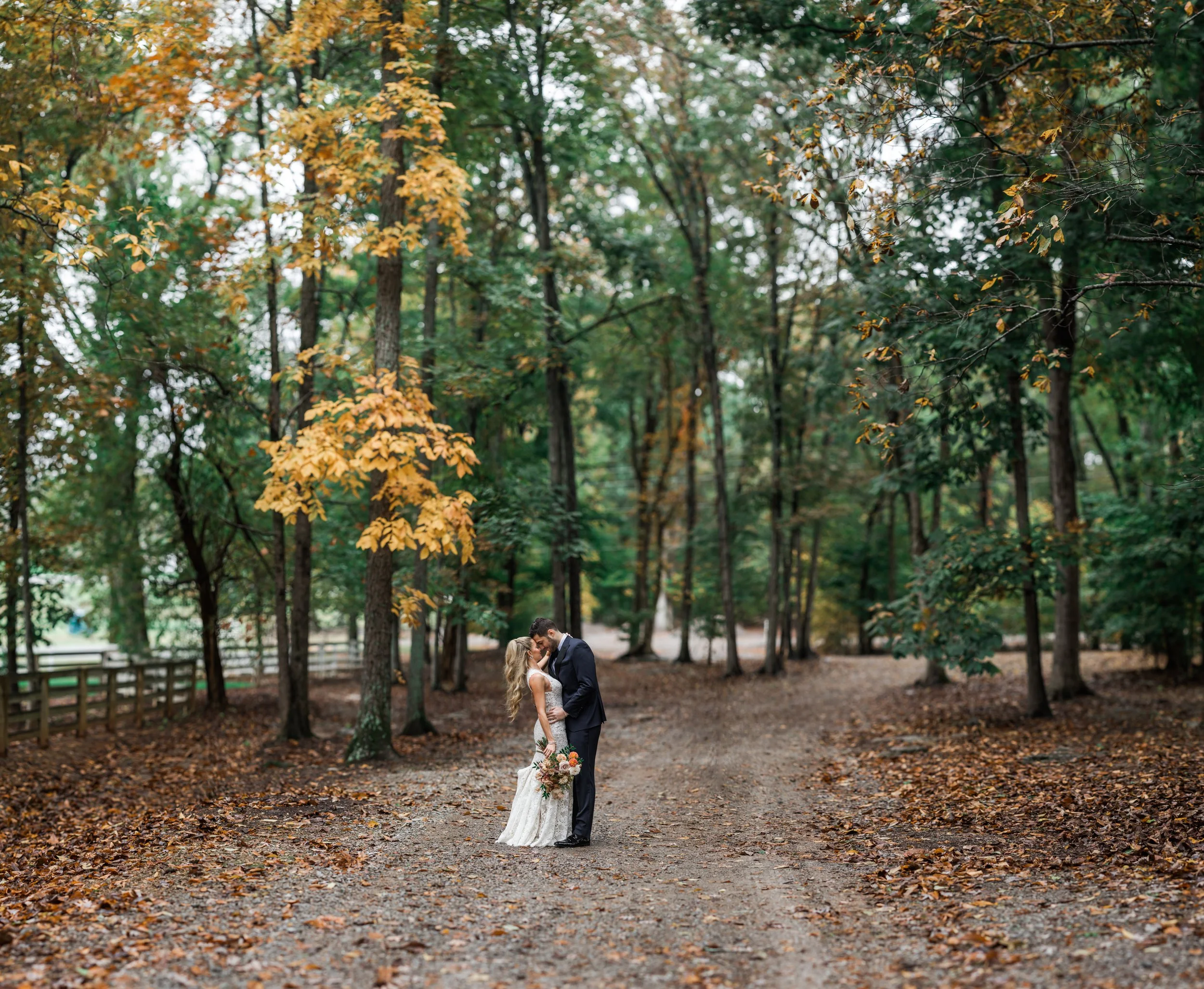 An elegant fall bridal bouquet featuring a sunset color palette of blush, terra cotta, rose gold, yellow, and copper. Florals accents of dahlias, garden roses, ranunculus, and double brownie tulips. Designed by Rosemary and Finch in Nashville, TN.