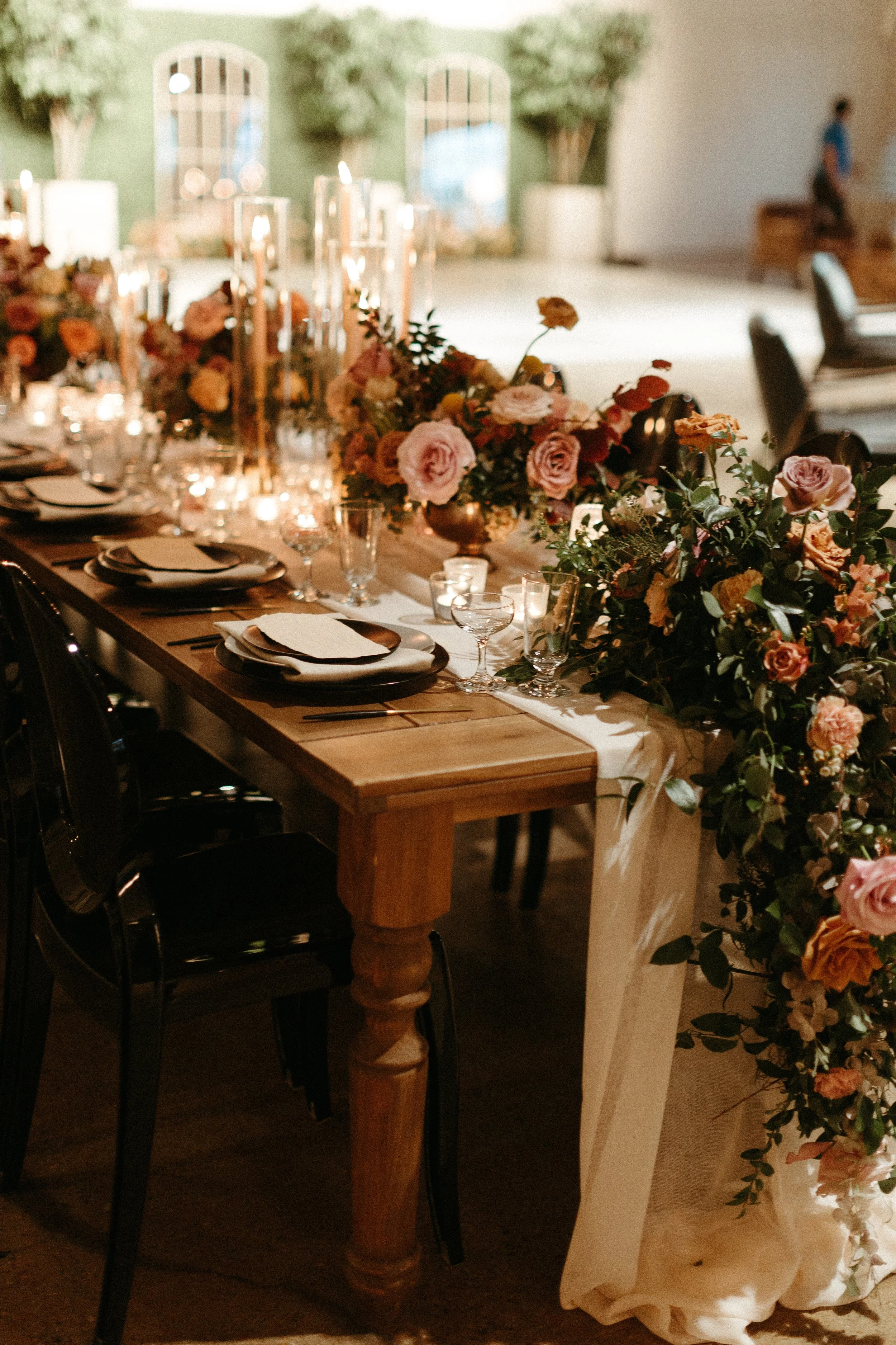 Gorgeous centerpieces bring warmth to this art deco 1920s inspired wedding with hues of terra cotta, dusty pink, mauve, and burgundy. Lush roses, ranunculus, and copper beech highlight the florals. Designed by Rosemary and Finch in Nashville, TN.
