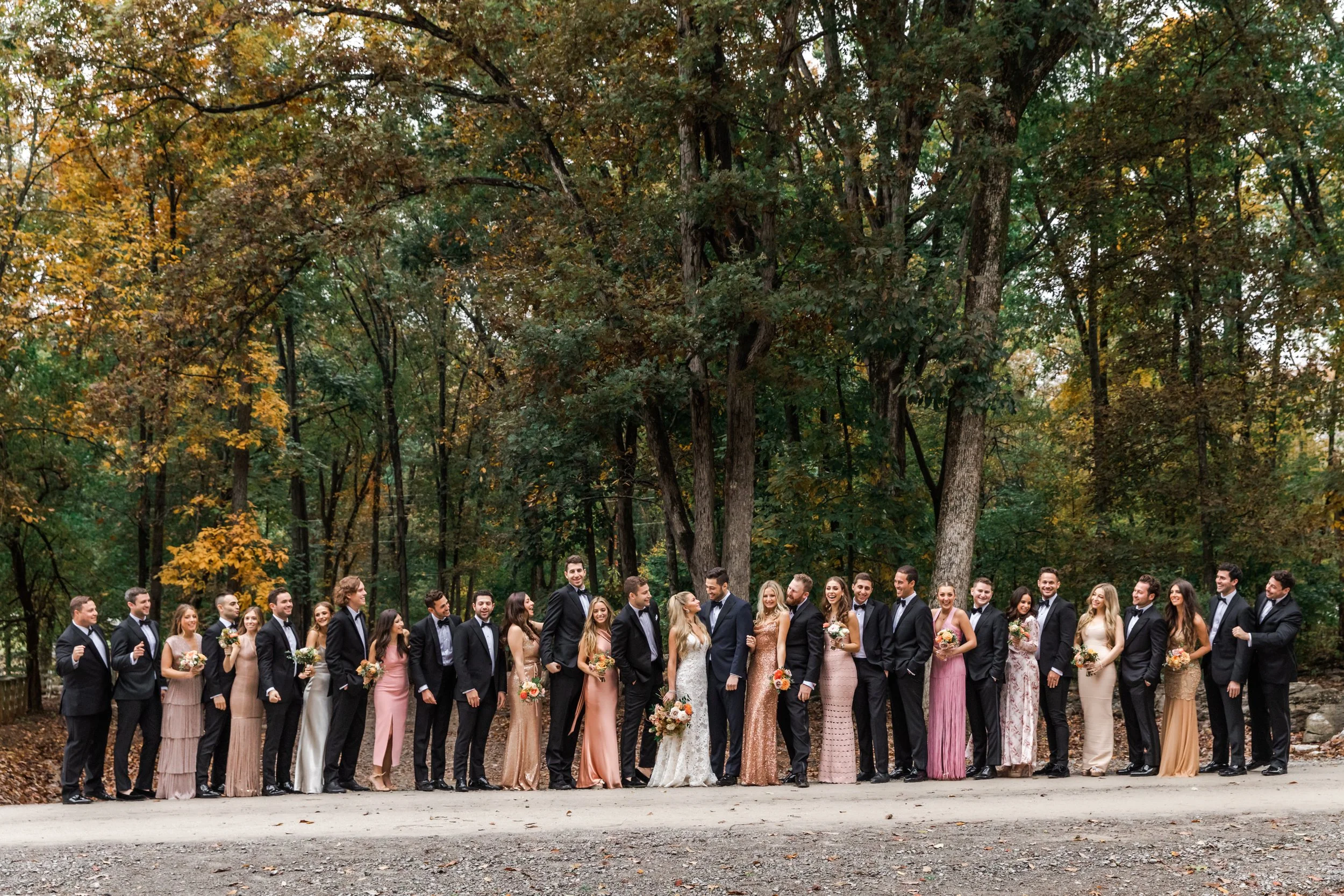 An elegant fall bridal bouquet featuring a sunset color palette of blush, terra cotta, rose gold, yellow, and copper. Florals accents of dahlias, garden roses, ranunculus, and double brownie tulips. Designed by Rosemary and Finch in Nashville, TN.