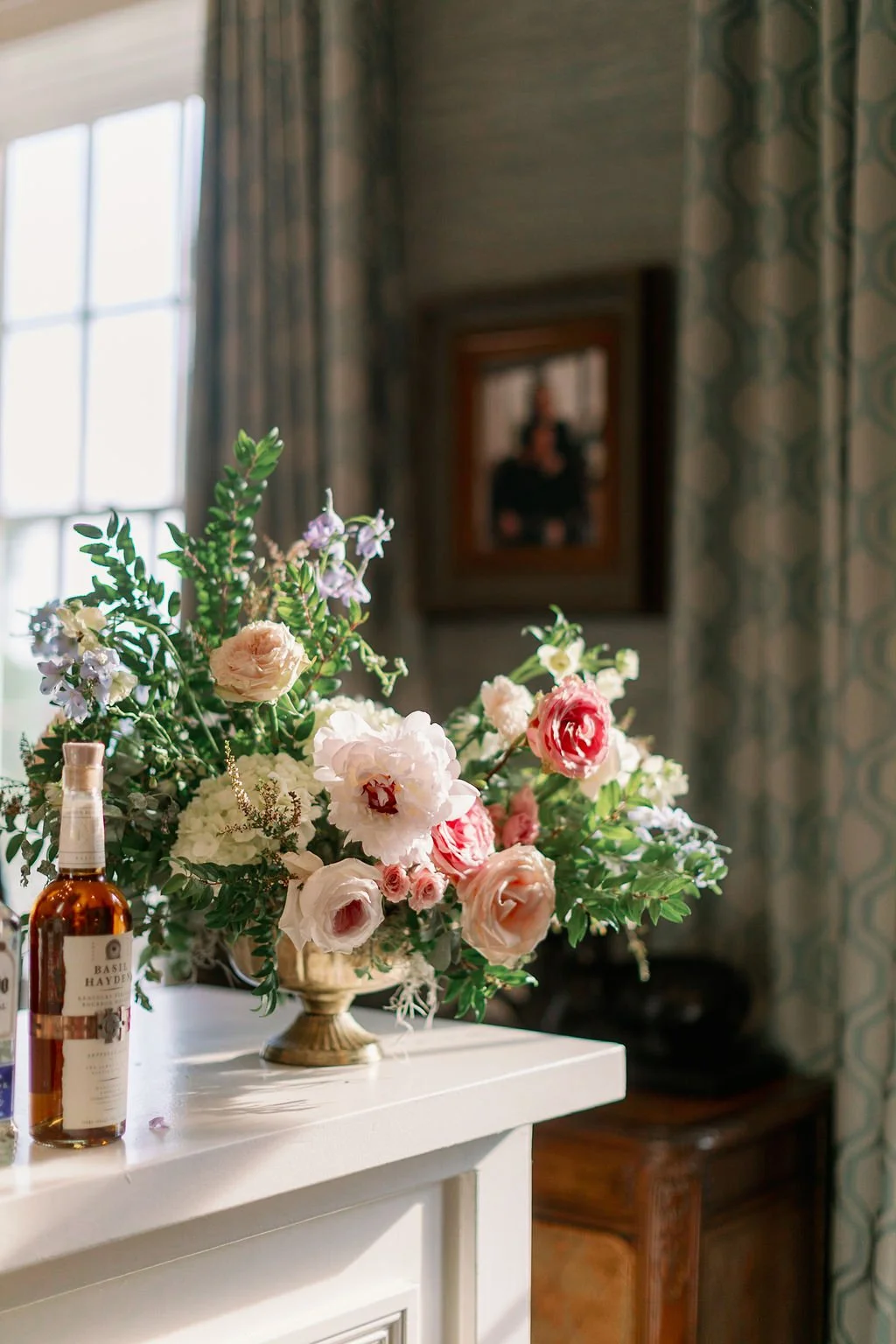 This garden-inspired reception features floral hues of blush, ivory, cream, pink, and hints of French blue along with centerpieces of pink roses, peonies, garden roses, blue delphinium, ranunculus, spirea and hydrangea. Designed by Rosemary & Finch i