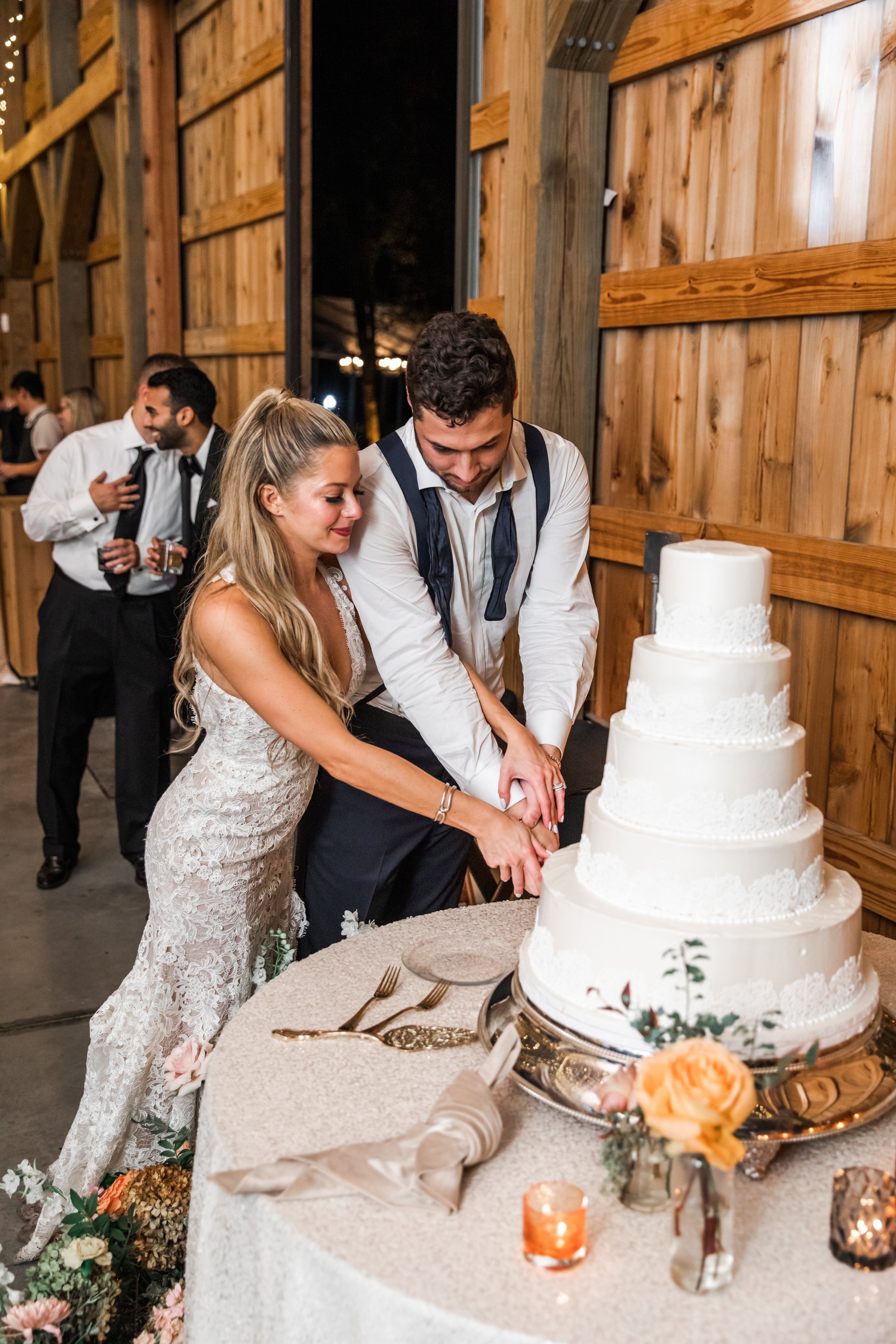 Elegant accents of fall florals, including roses, dahlias, and fall greenery, decorate the reception space of this autumnal wedding. Hues of terra cotta, rose gold, yellow, copper, and dusty pink. Designed by Rosemary and Finch in Nashville, TN.