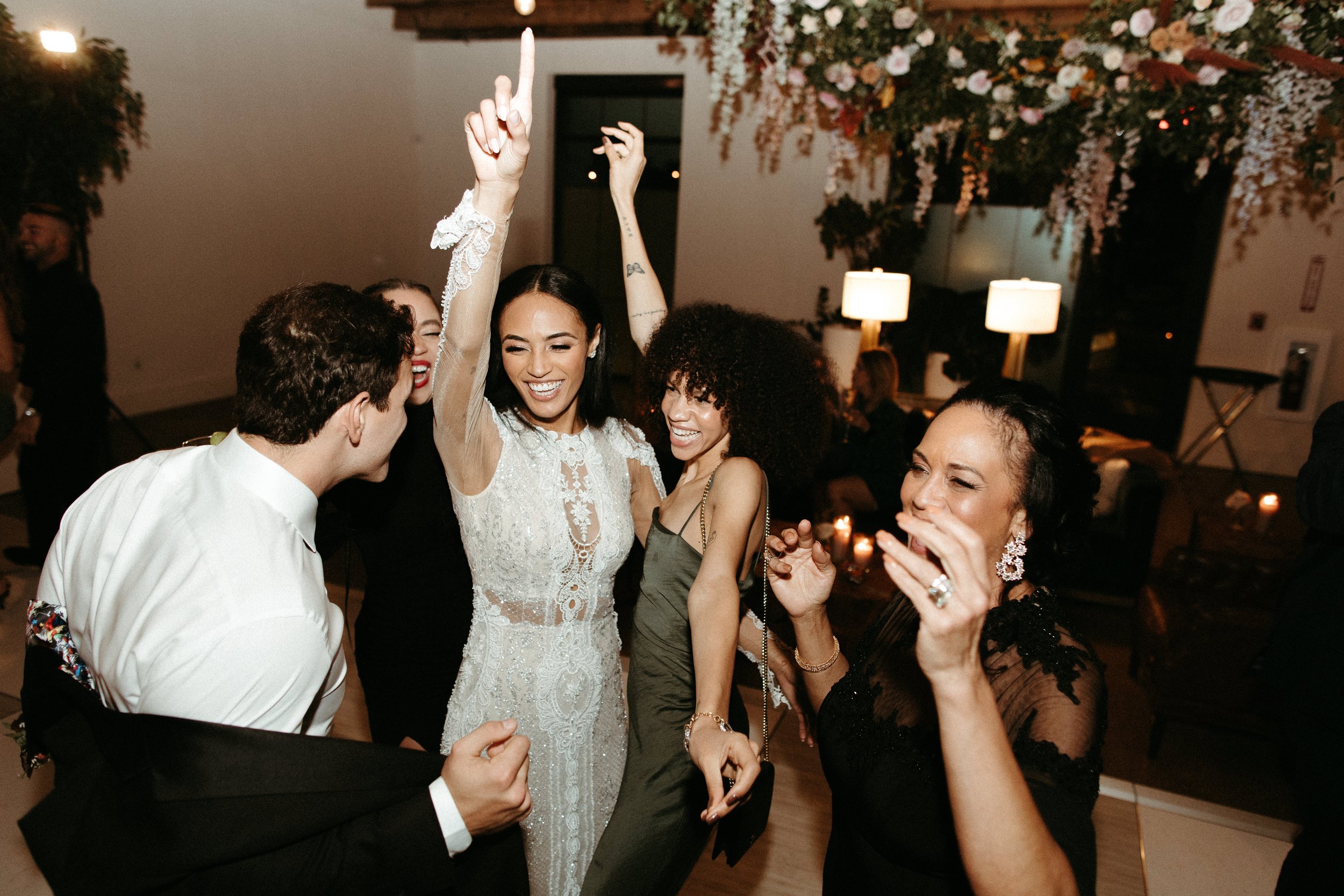 Stunning floral installations bring warmth to this Great Gatsby inspired wedding with florals of terra cotta, dusty pink, and burgundy hues. Petal heavy roses, wisteria, copper beech, and pink pampas grass accents. Designed by Rosemary and Finch in N