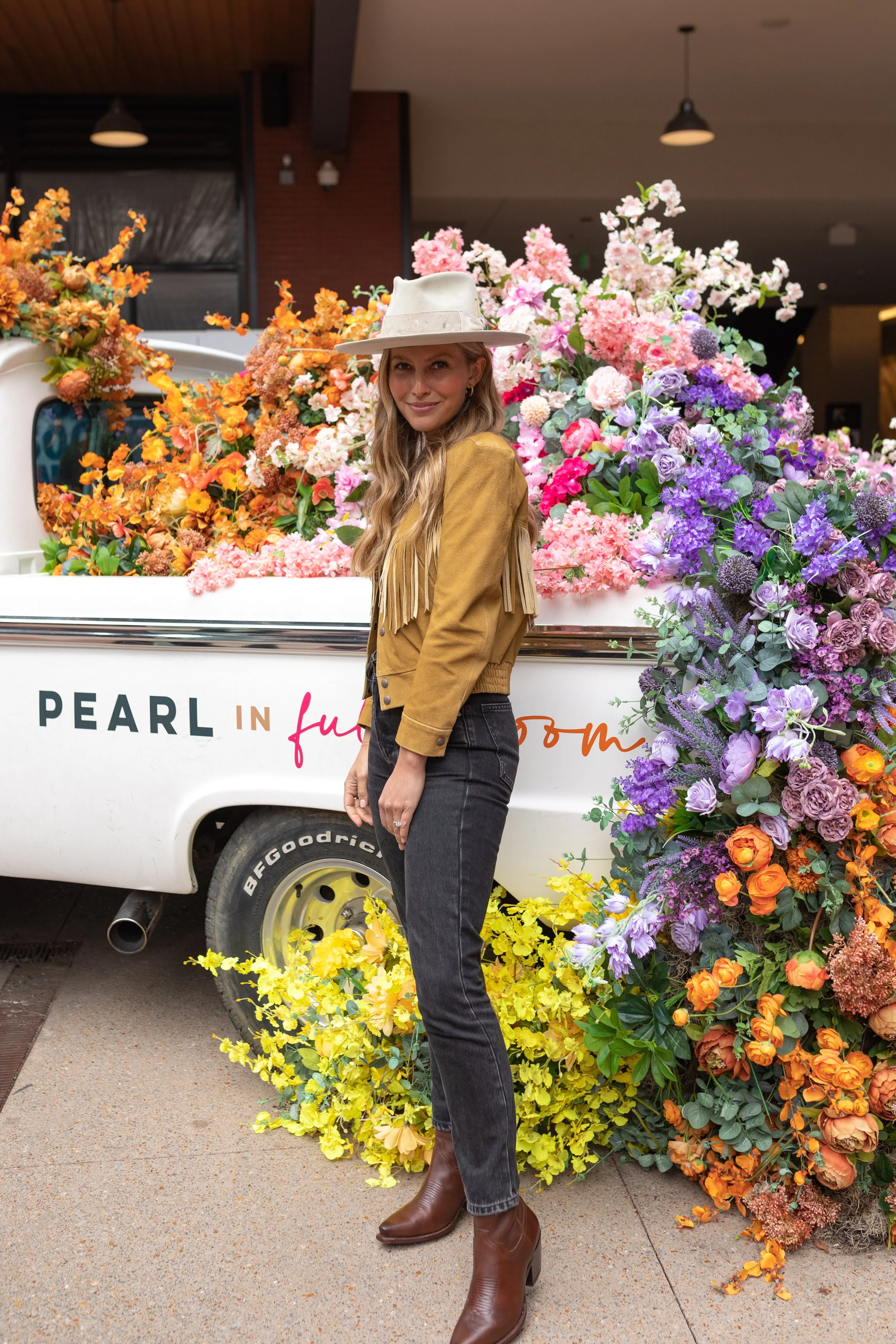 Cheerful pickup truck installation composed of silk floral hues in pink, magenta, lavender, coral, orange, yellow, and mixed greens bring to life this spring Fifth + Broadway event in Nashville, TN. Design by Rosemary and Finch.
