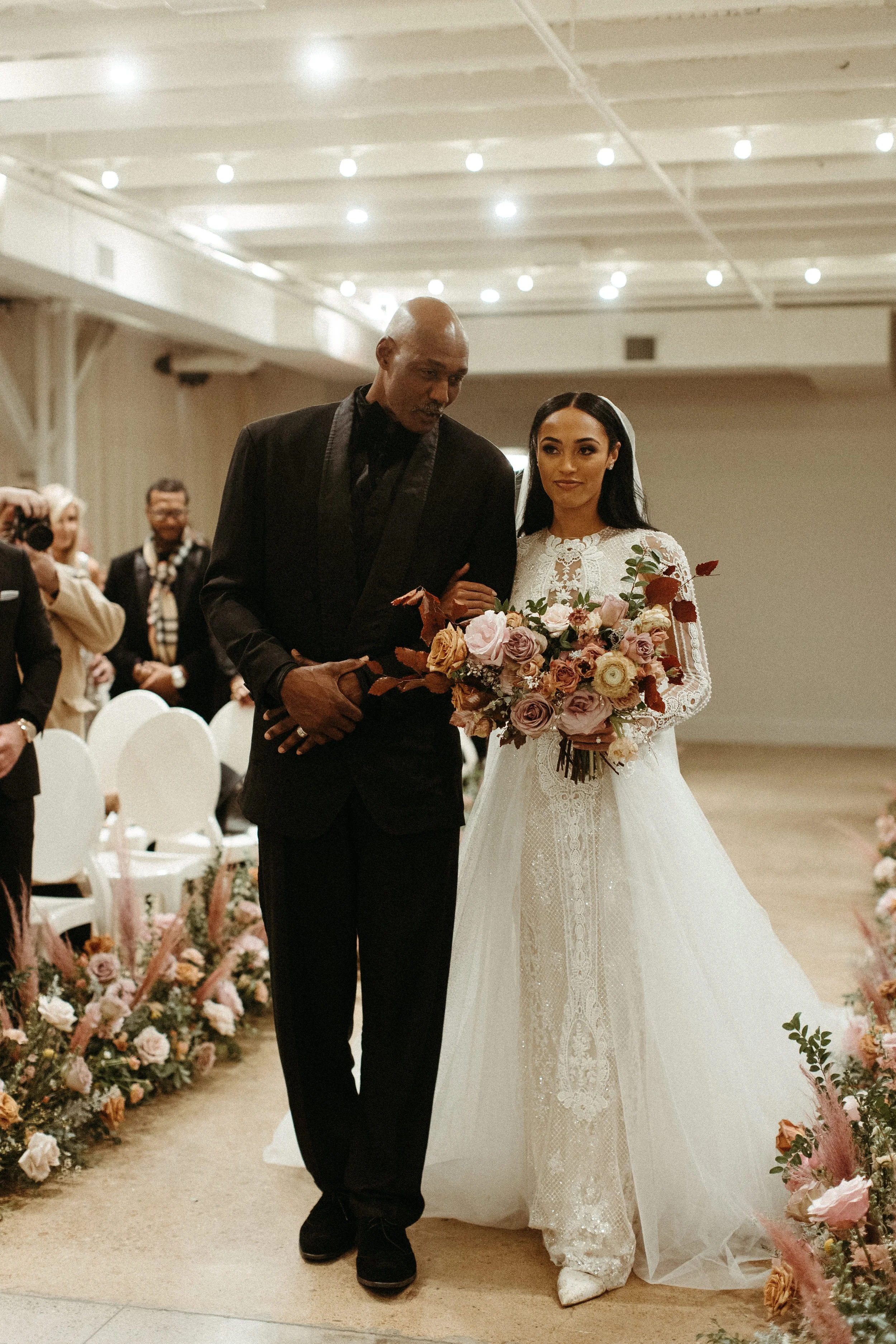This elegant bridal bouquet brought hues of mauve, dusty pink, cream, burgundy, and terra cotta to this winter wedding. Lush with petal heavy roses, ranunculus, spray roses, copper beech, and greenery. Designed by Rosemary and Finch in Nashville, TN.
