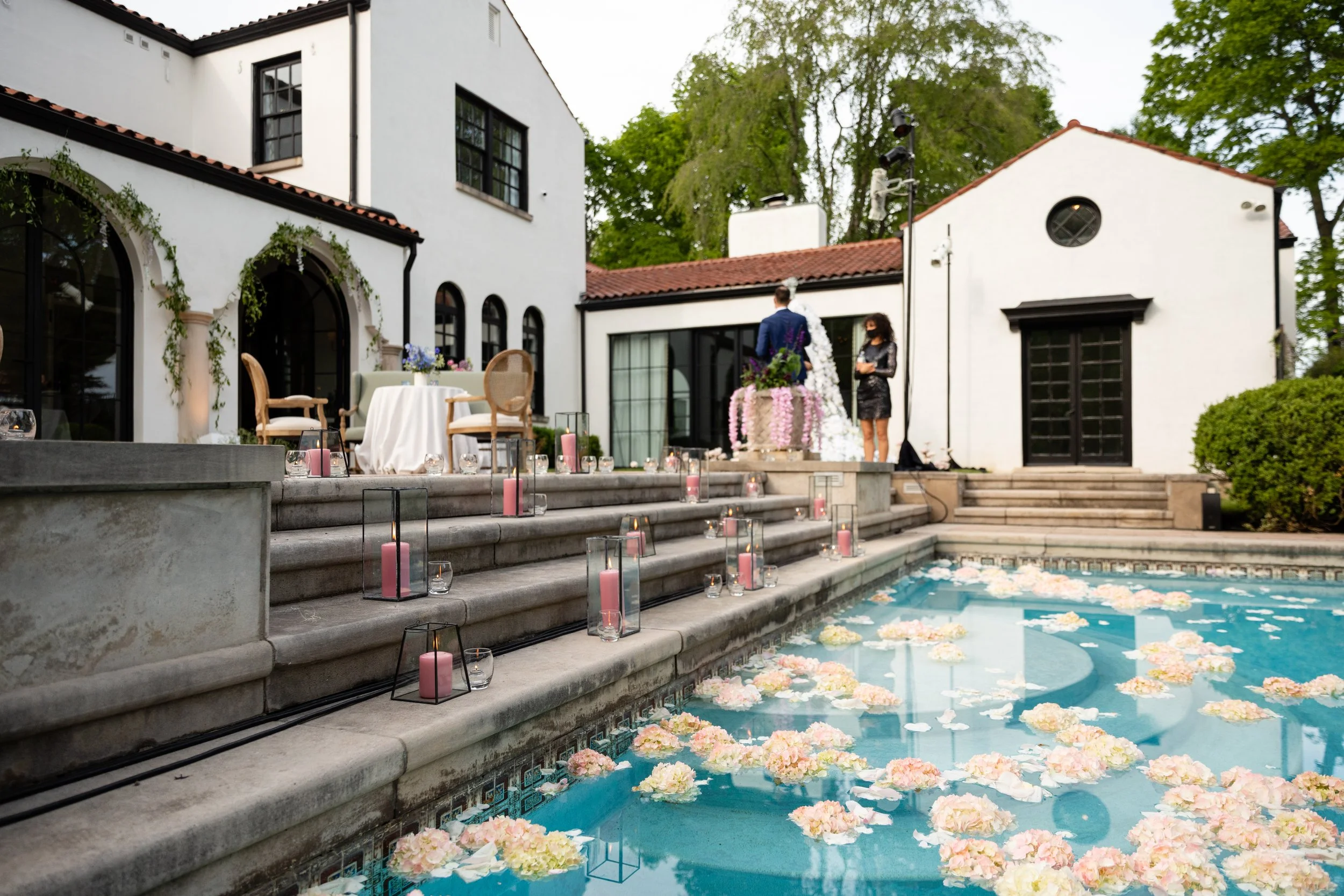 Bridgerton inspired engagement party at a private home in Nashville, TN with pastel candles and flowers floating in the pool.