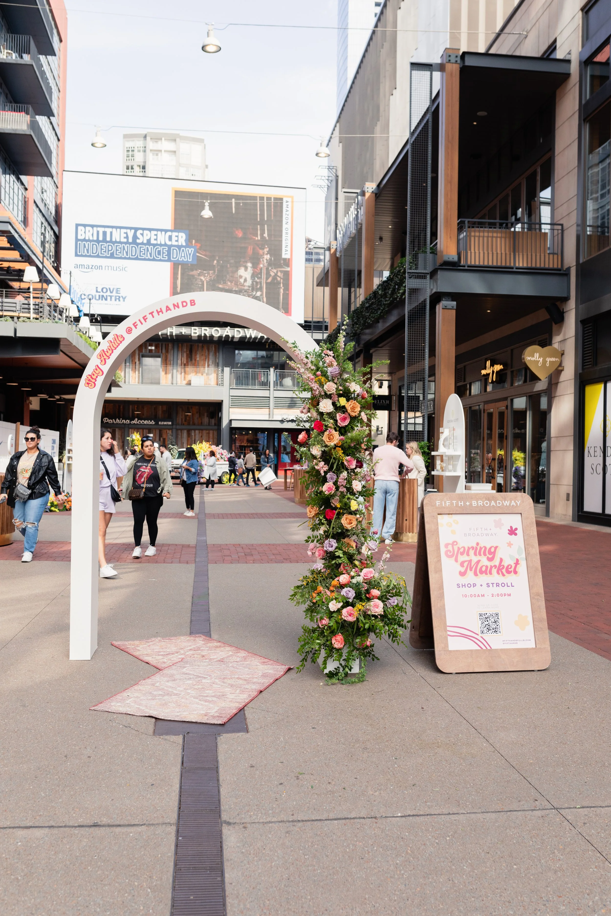 Bright spring floral hues of pink, lavender, coral, magenta, and yellow inspire the event space of Fifth + Broadway in Nashville, TN. Florals composed of roses, ranunculus, sweet peas, butterfly ranunculus, mixed greenery. Design by Rosemary and Finc
