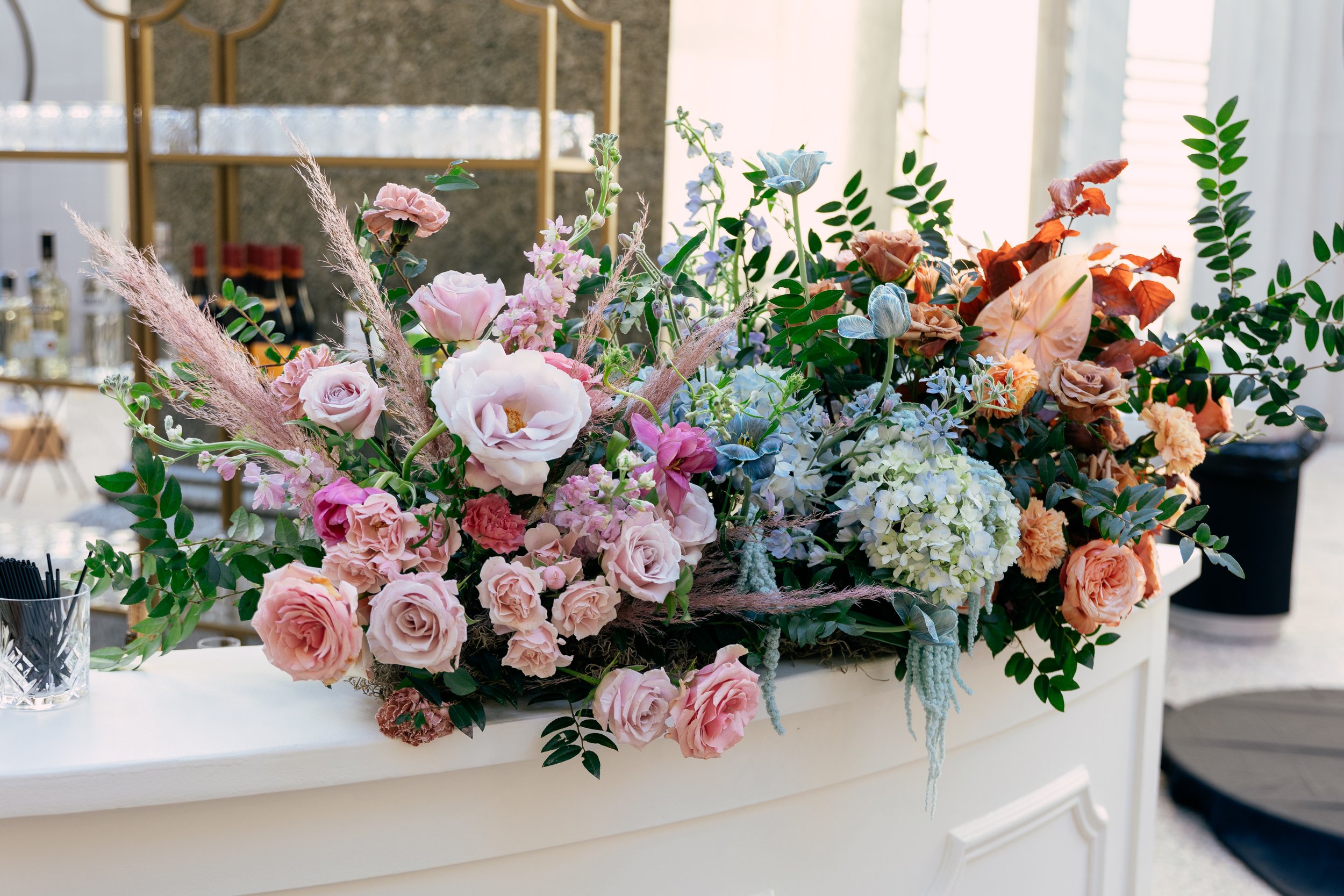 Bright and colorful arrangements create an inviting scene for guests at the TPAC Gala in Nashville Tennessee. Florals composed of roses, hydrangeas, tulips, snapdragons, dried palm, and anthurium. Designed by Rosemary and Finch.