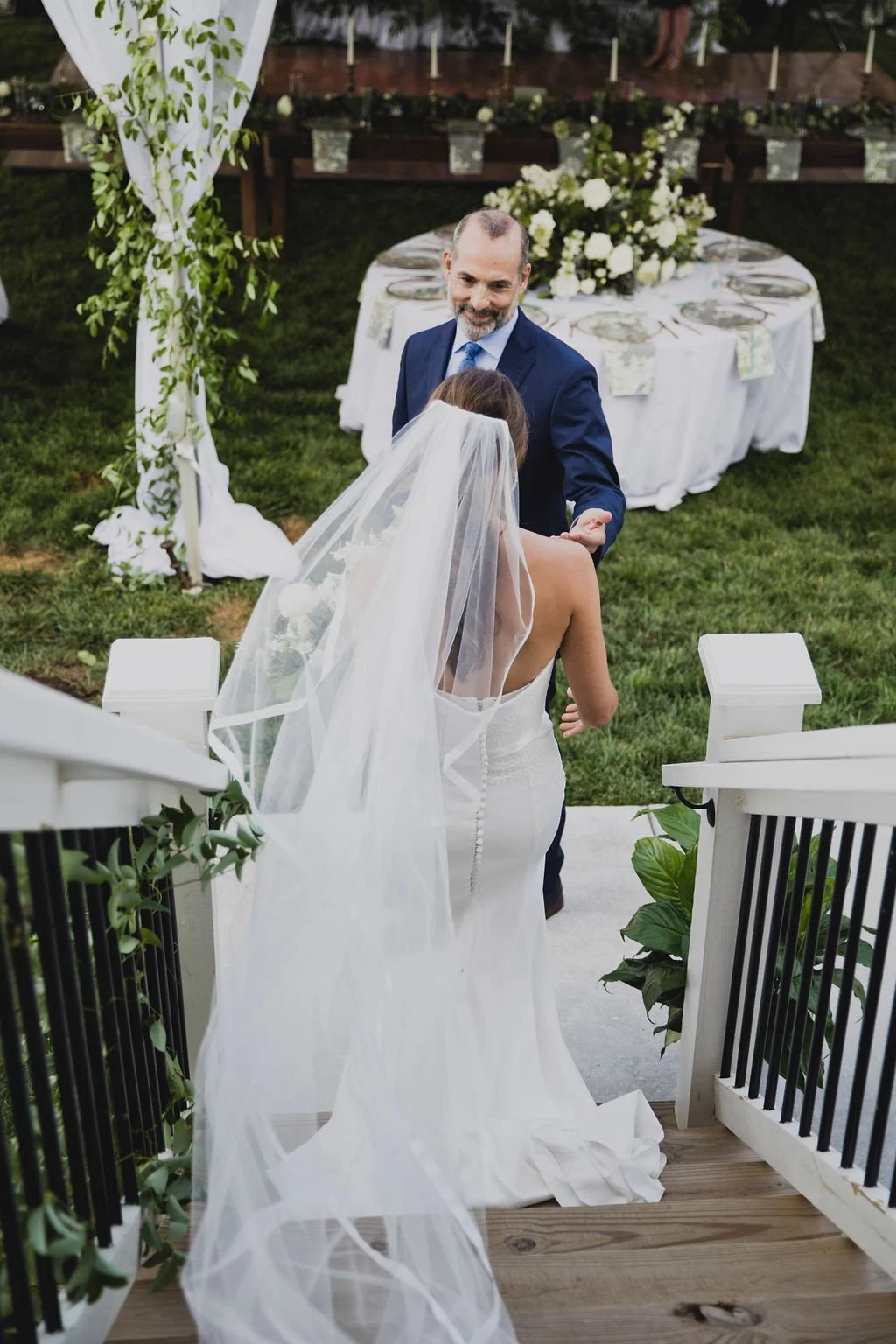 A bridal bouquet filled with ranunculus, delphinium, white sweet pea, spirea, garden roses, and jasmine vine. Designed by Rosemary and Finch in Nashville, TN.