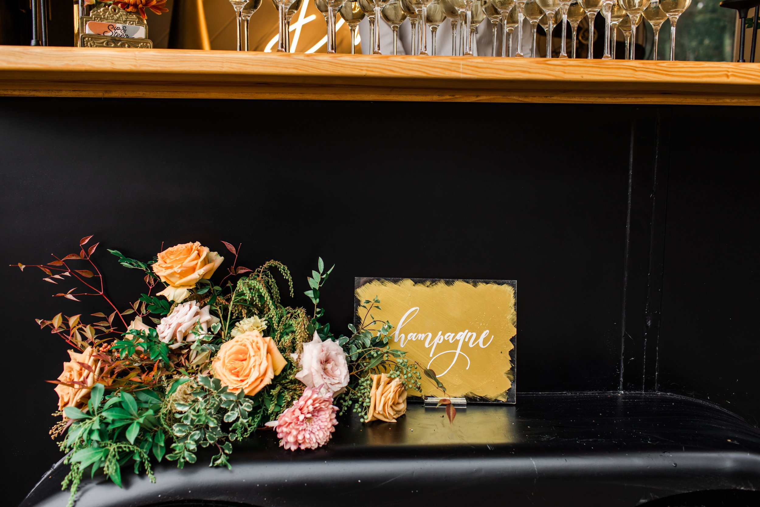 Elegant accents of fall florals, including roses, dahlias, and fall greenery, decorate the reception space of this autumnal wedding. Hues of terra cotta, rose gold, yellow, copper, and dusty pink. Designed by Rosemary and Finch in Nashville, TN.