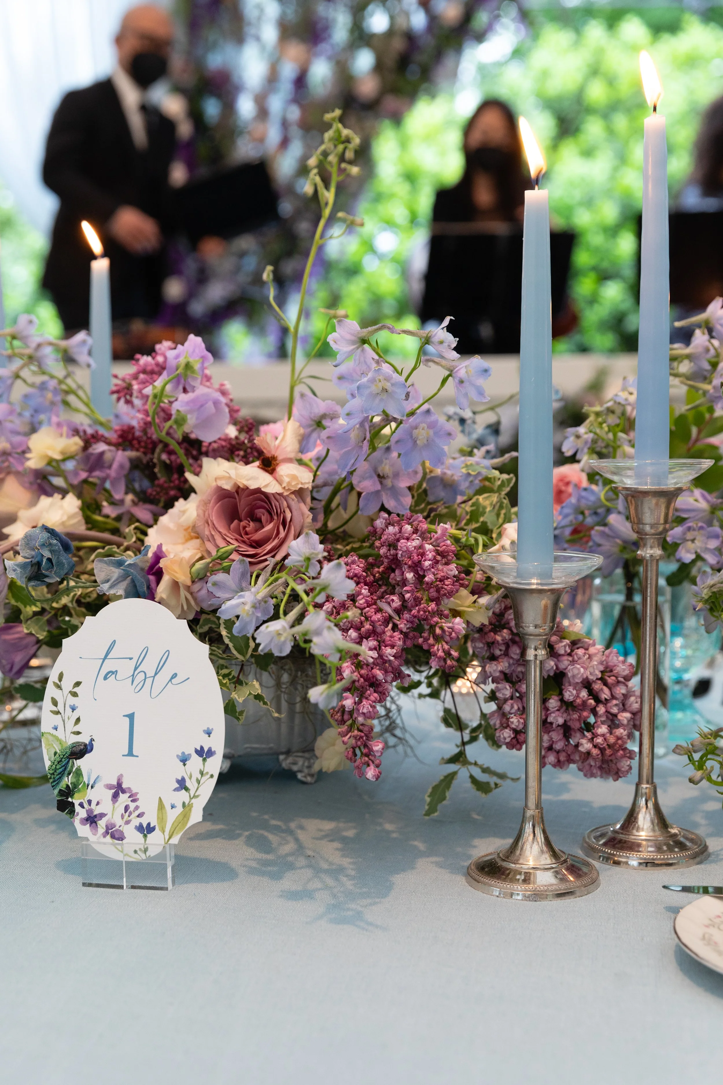 Growing, fresh floral centerpieces with blush garden roses, lilac, blue sweet peas, ranunculus, lavender delphinium, globe allium, and natural greenery for a tented Bridgerton inspired engagement party at a private home in Nashville, TN. Flower by Te