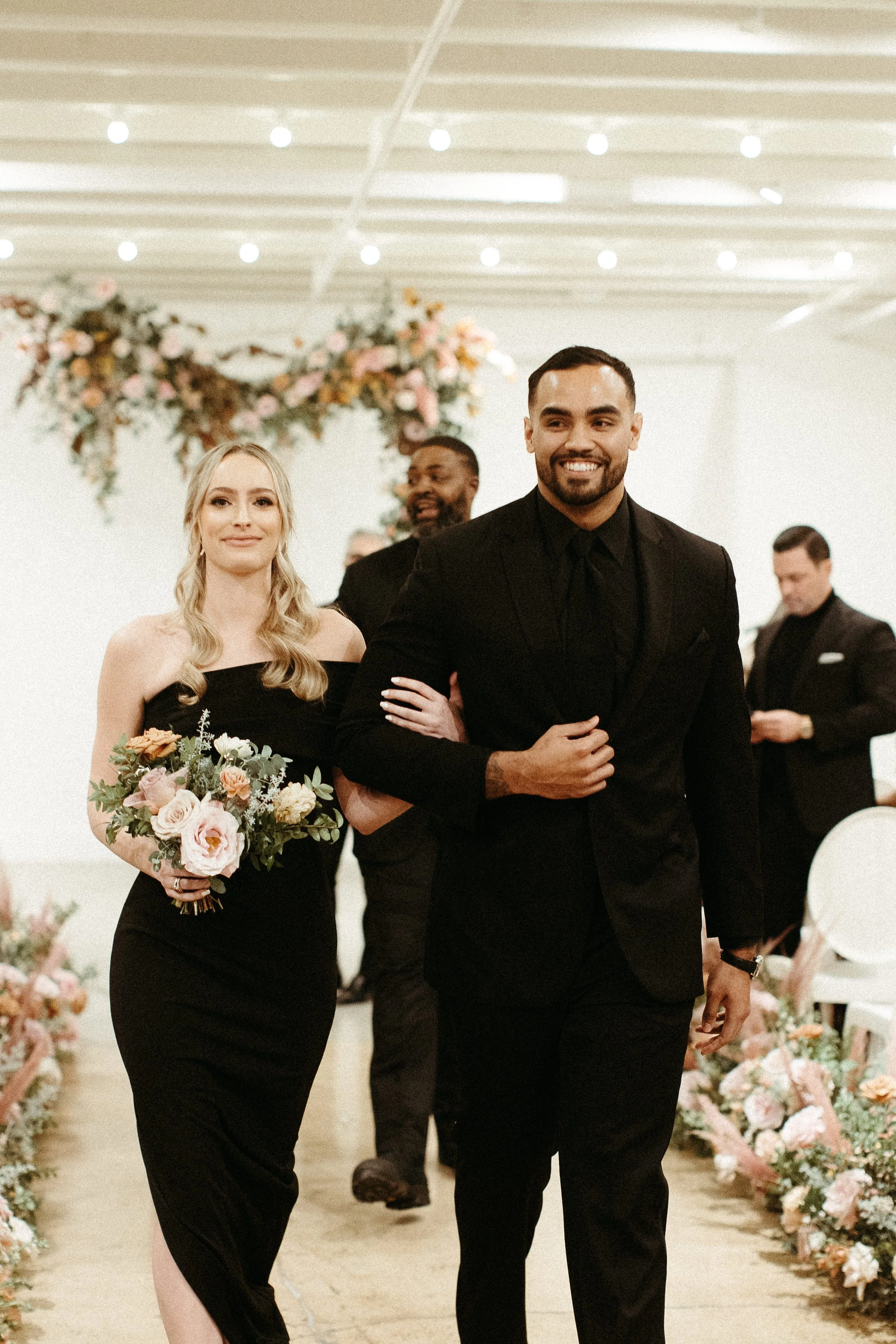 Beautiful bridal party bouquets brought warm hues of dusty pink, terra cotta, mauve, and burgundy. Art deco wedding florals comprised of roses, ranunculus, dried branches, and greenery. Designed by Rosemary and Finch in Nashville, TN.