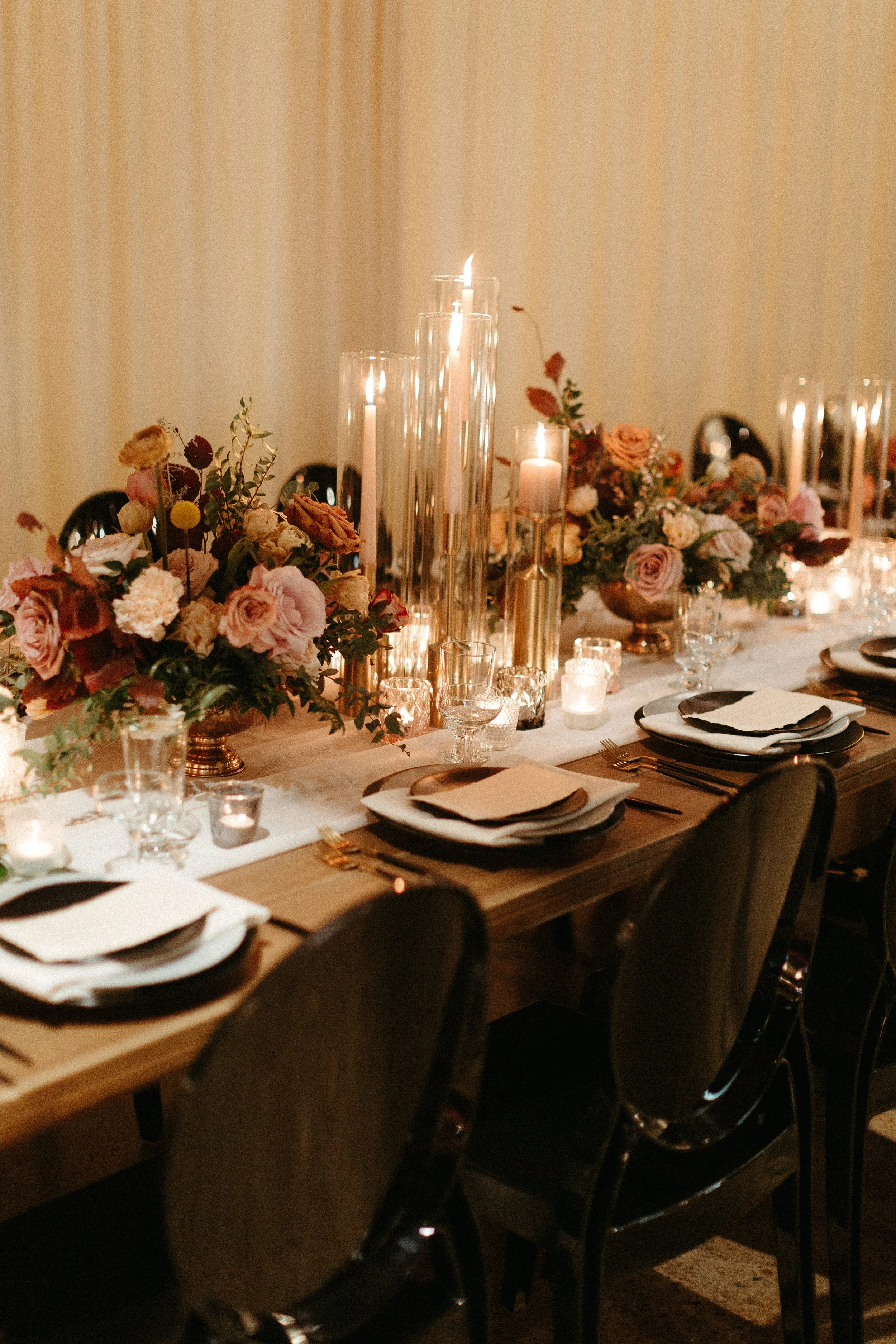 Gorgeous centerpieces bring warmth to this art deco 1920s inspired wedding with hues of terra cotta, dusty pink, mauve, and burgundy. Lush roses, ranunculus, and copper beech highlight the florals. Designed by Rosemary and Finch in Nashville, TN.