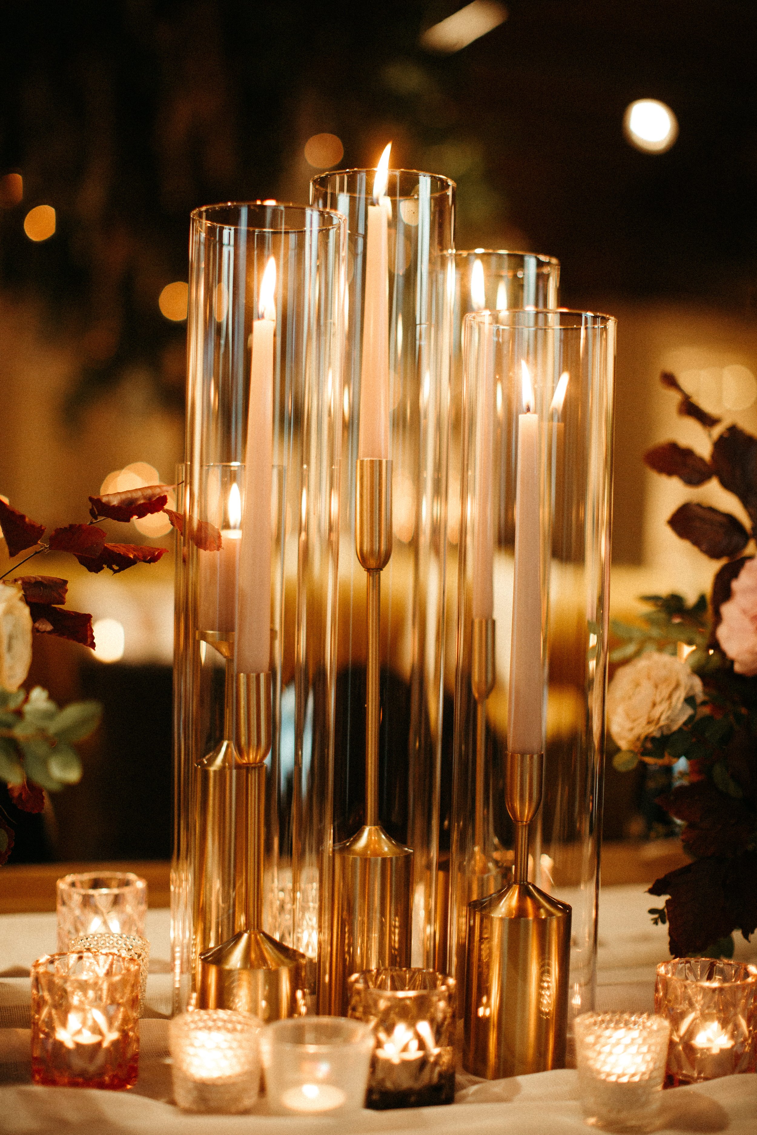 1920s and Great Gatsby inspired tablescapes are highlighted by gorgeous gold candlesticks, blush tapers, and taupe and bronze votives. Designed with floral hues of terra cotta, mauve, and dusty rose. Designed by Rosemary and Finch in Nashville, TN.