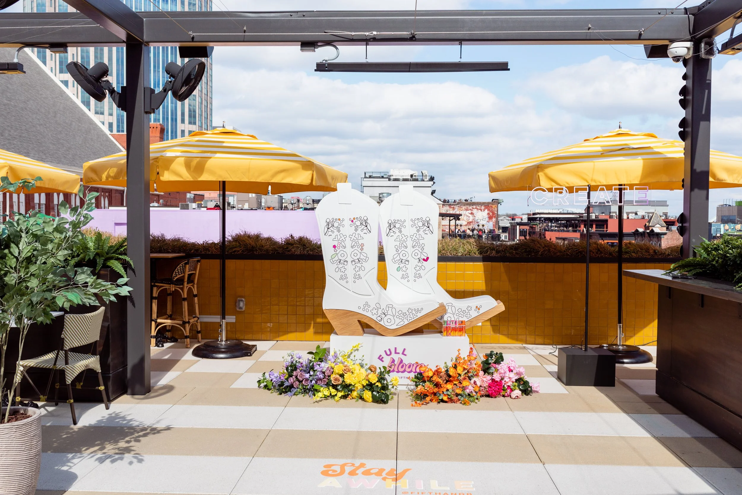 Vibrant floral installations composed of silk floral hues in pink, magenta, lavender, coral, orange, yellow, and mixed greens bring to life this spring Fifth + Broadway event in Nashville, TN. Design by Rosemary and Finch.