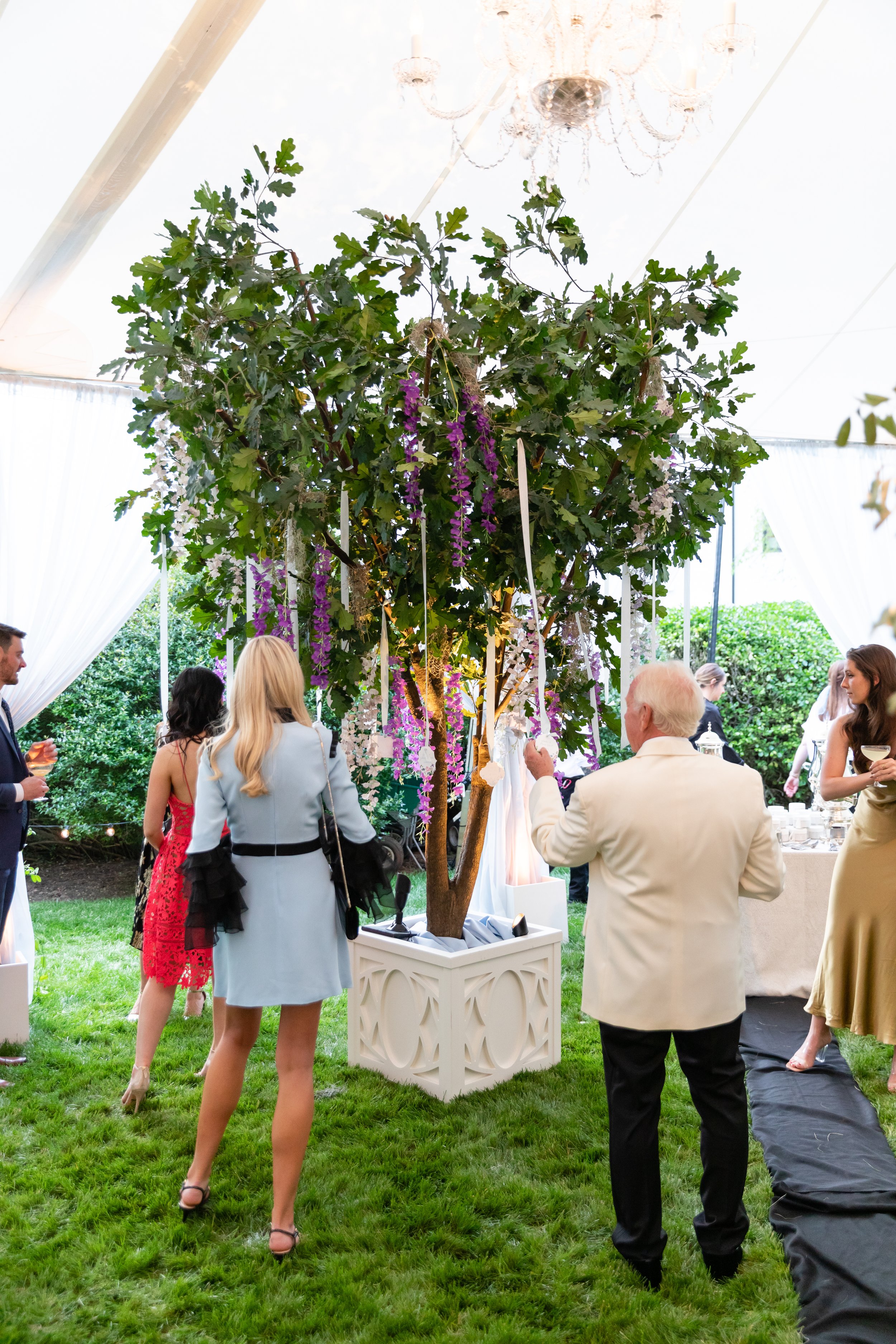 Bridgerton inspired engagement party at a private home in Nashville, TN with lush, organic floral tree installations of wisteria, spanish moss, and pastel blooms. Nashville wedding floral designer, Rosemary & Finch.