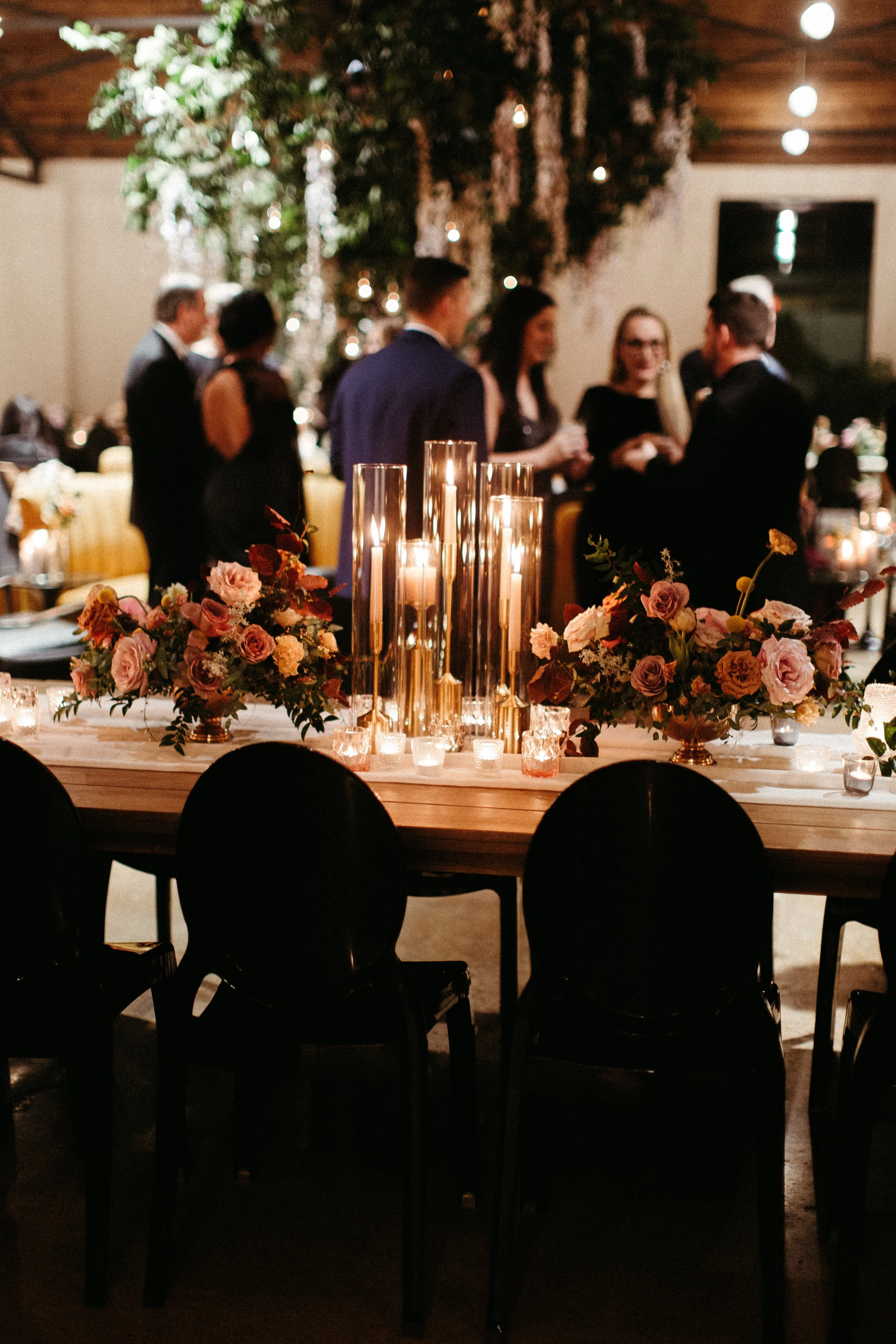 Gorgeous centerpieces bring warmth to this art deco 1920s inspired wedding with hues of terra cotta, dusty pink, mauve, and burgundy. Lush roses, ranunculus, and copper beech highlight the florals. Designed by Rosemary and Finch in Nashville, TN.