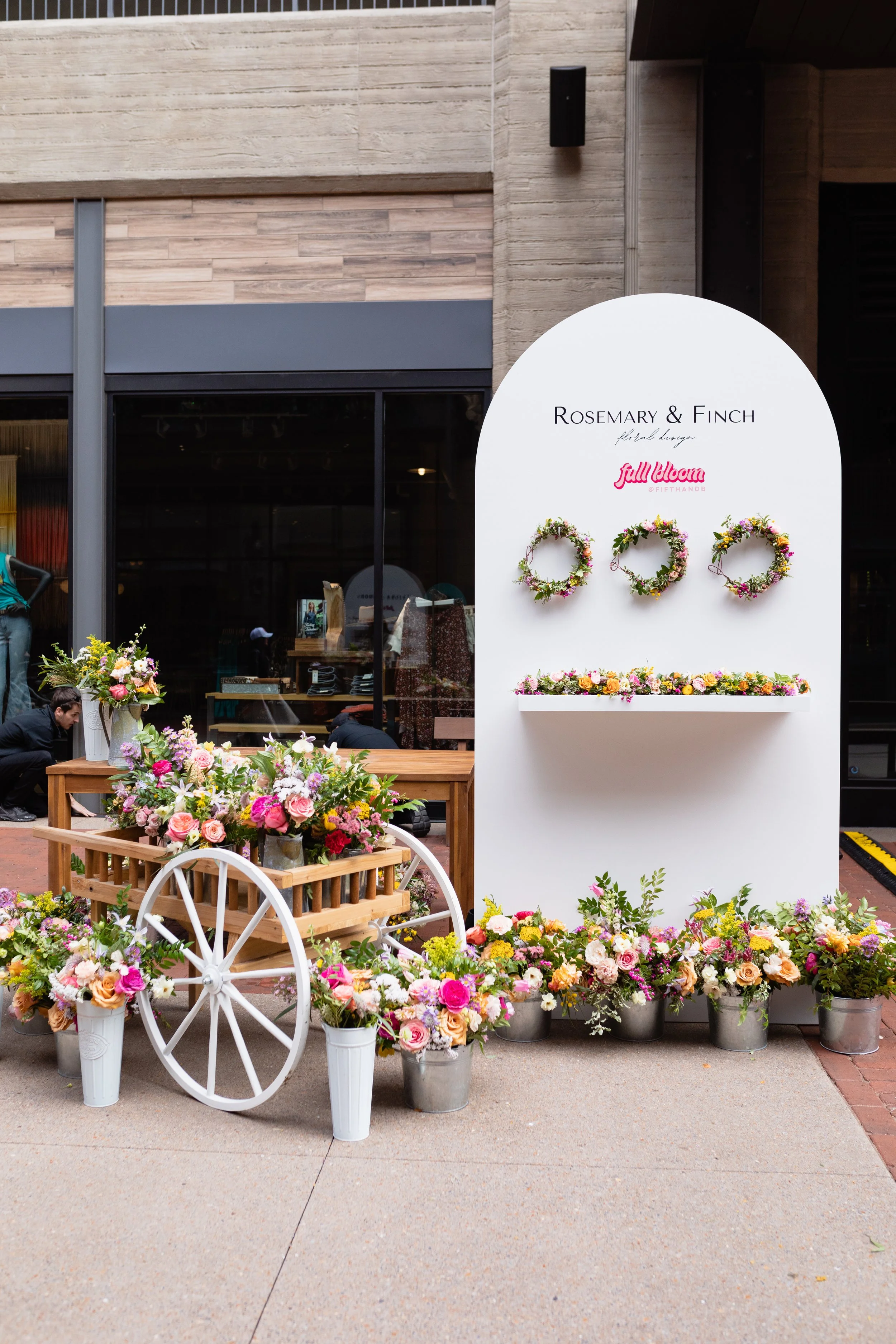 Bright spring floral hues of pink, lavender, coral, magenta, and yellow inspire the event space of Fifth + Broadway in Nashville, TN. Florals composed of roses, ranunculus, sweet peas, butterfly ranunculus, mixed greenery. Design by Rosemary and Finc