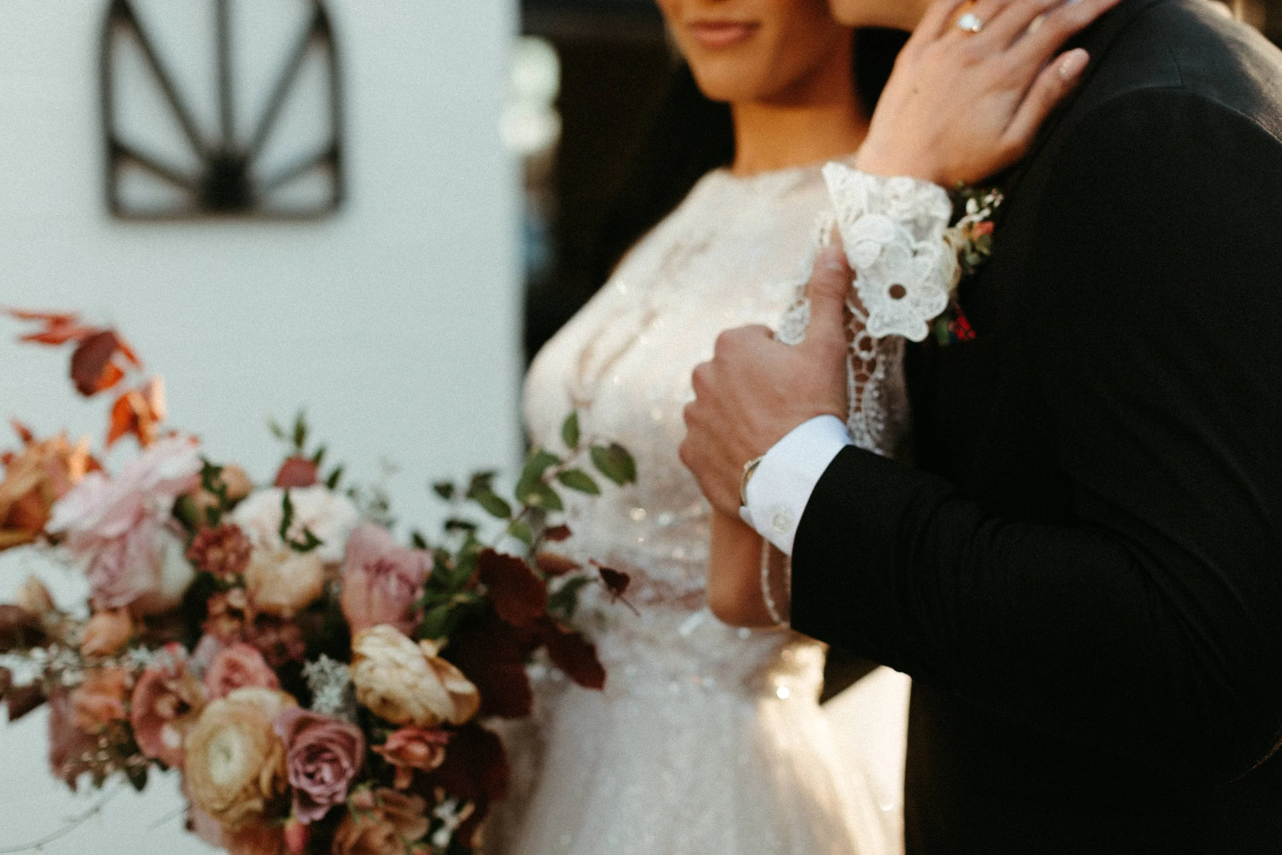 This elegant bridal bouquet brought hues of mauve, dusty pink, cream, burgundy, and terra cotta to this winter wedding. Lush with petal heavy roses, ranunculus, spray roses, copper beech, and greenery. Designed by Rosemary and Finch in Nashville, TN.