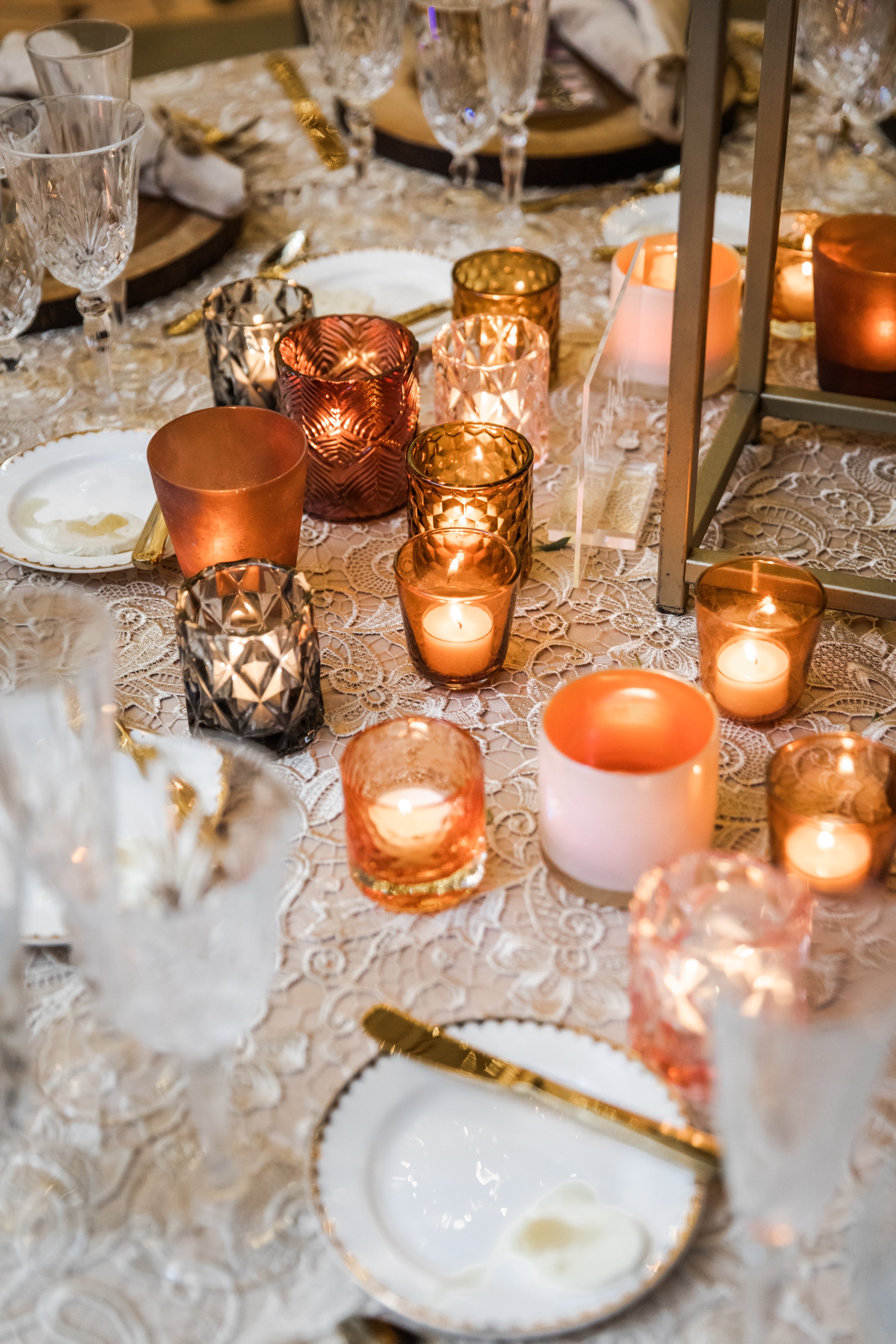 Gorgeous autumnal elevated centerpieces featuring garden roses, ranunculus, and dahlias are adorned with fairy ring candles creating hues of copper, blush, terra cotta, and yellow. Designed by Rosemary and Finch in Nashville, TN.