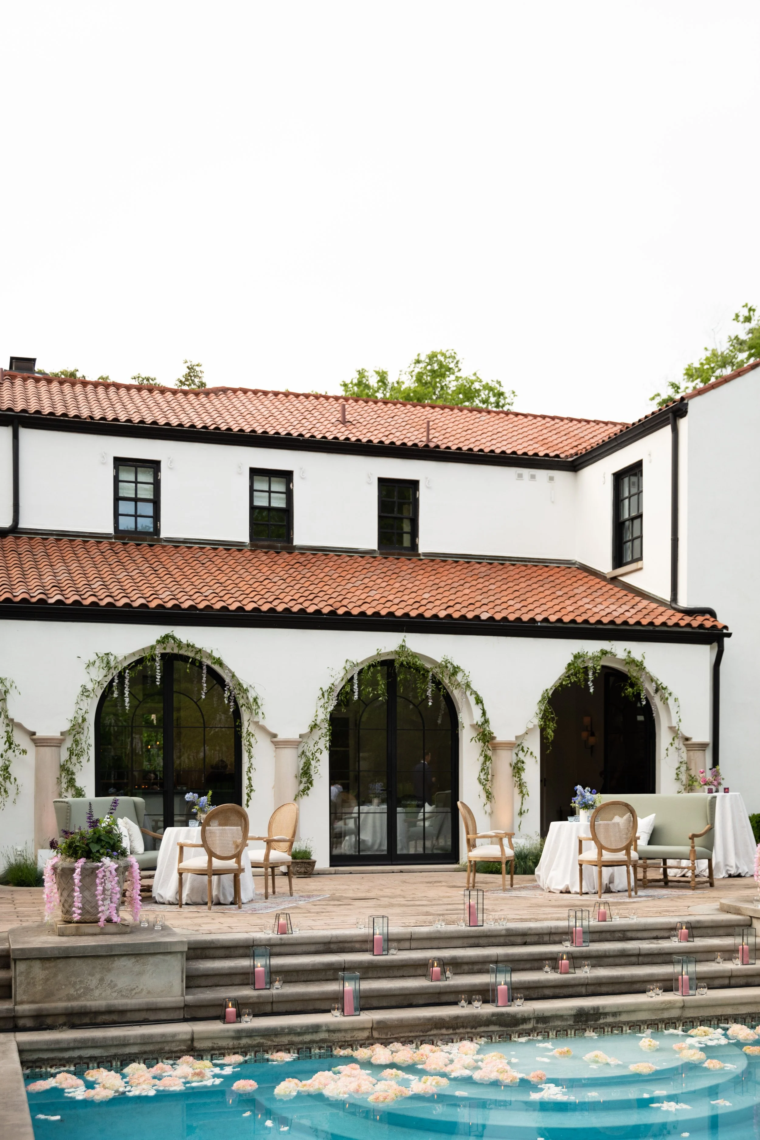 Bridgerton inspired engagement party at a private home in Nashville, TN with pastel candles and flowers floating in the pool.