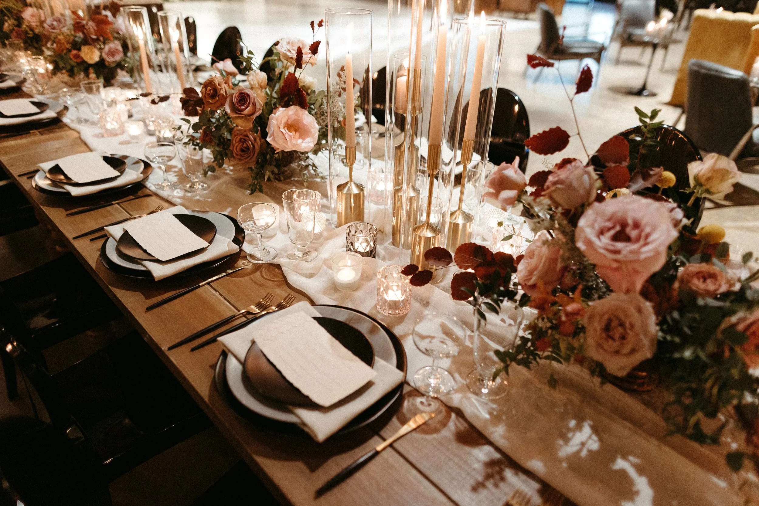 Gorgeous centerpieces bring warmth to this art deco 1920s inspired wedding with hues of terra cotta, dusty pink, mauve, and burgundy. Lush roses, ranunculus, and copper beech highlight the florals. Designed by Rosemary and Finch in Nashville, TN.