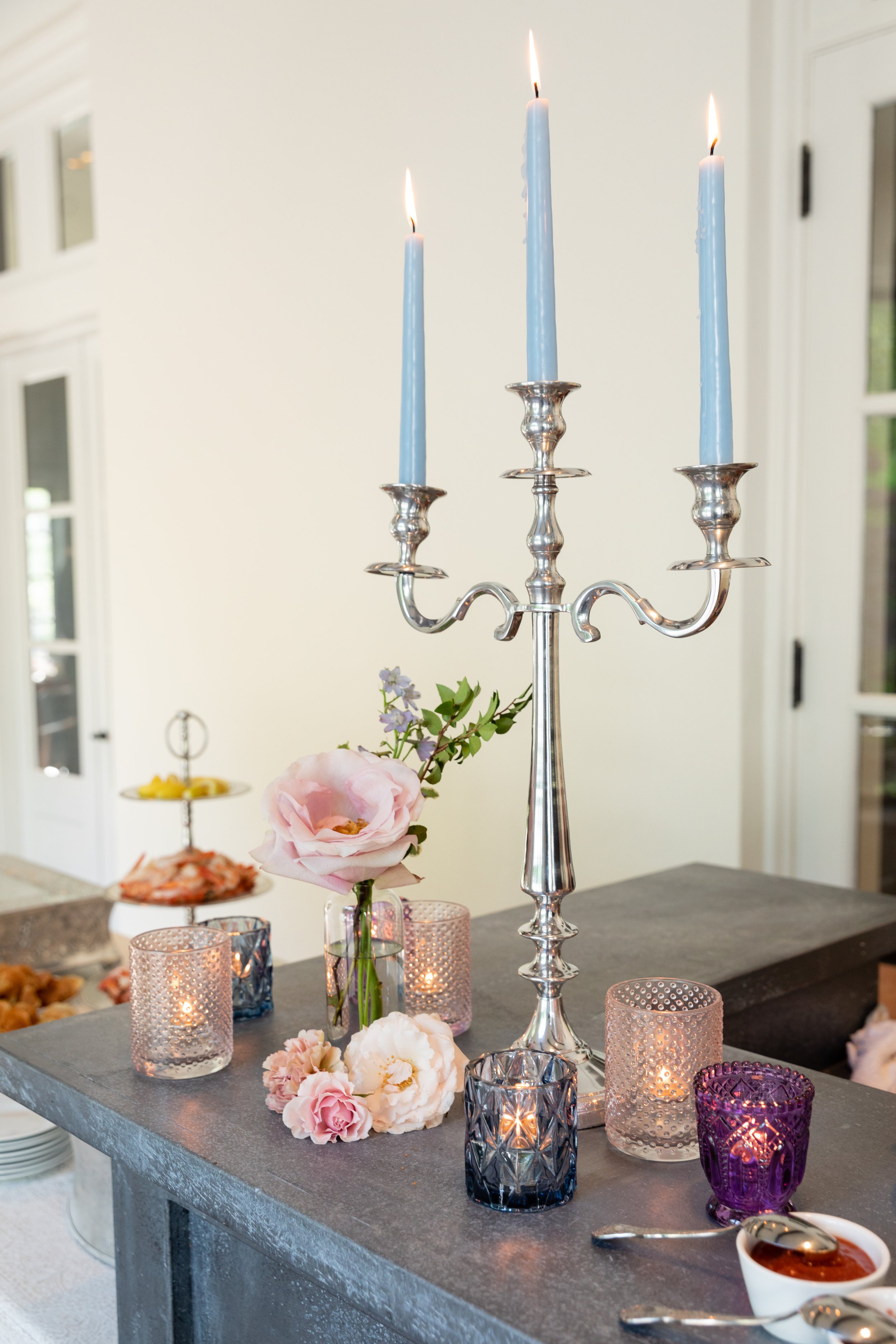 Bridgerton inspired engagement party at a private home in Nashville, TN with organic florals of wisteria, spanish moss & pastel blooms. Silver candelabra with light blue tapers and styled flowers. Nashville wedding floral designer, Rosemary & Finch.