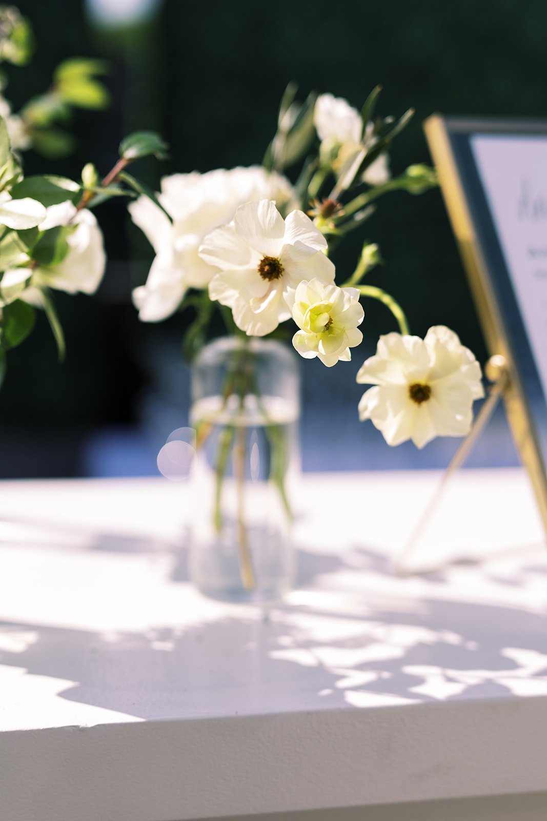 Classic white, cream, and blush wedding flowers. Florals composed of roses, ranunculus, Queen Anne’s lace, and greenery. Designed by Rosemary and Finch in Nashville, TN.