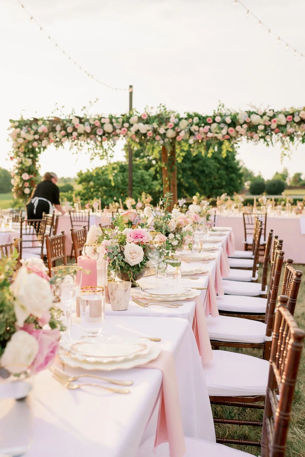 This garden-inspired reception features floral hues of blush, ivory, cream, pink, and hints of French blue along with centerpieces of pink roses, peonies, garden roses, blue delphinium, ranunculus, spirea and hydrangea. Designed by Rosemary & Finch i