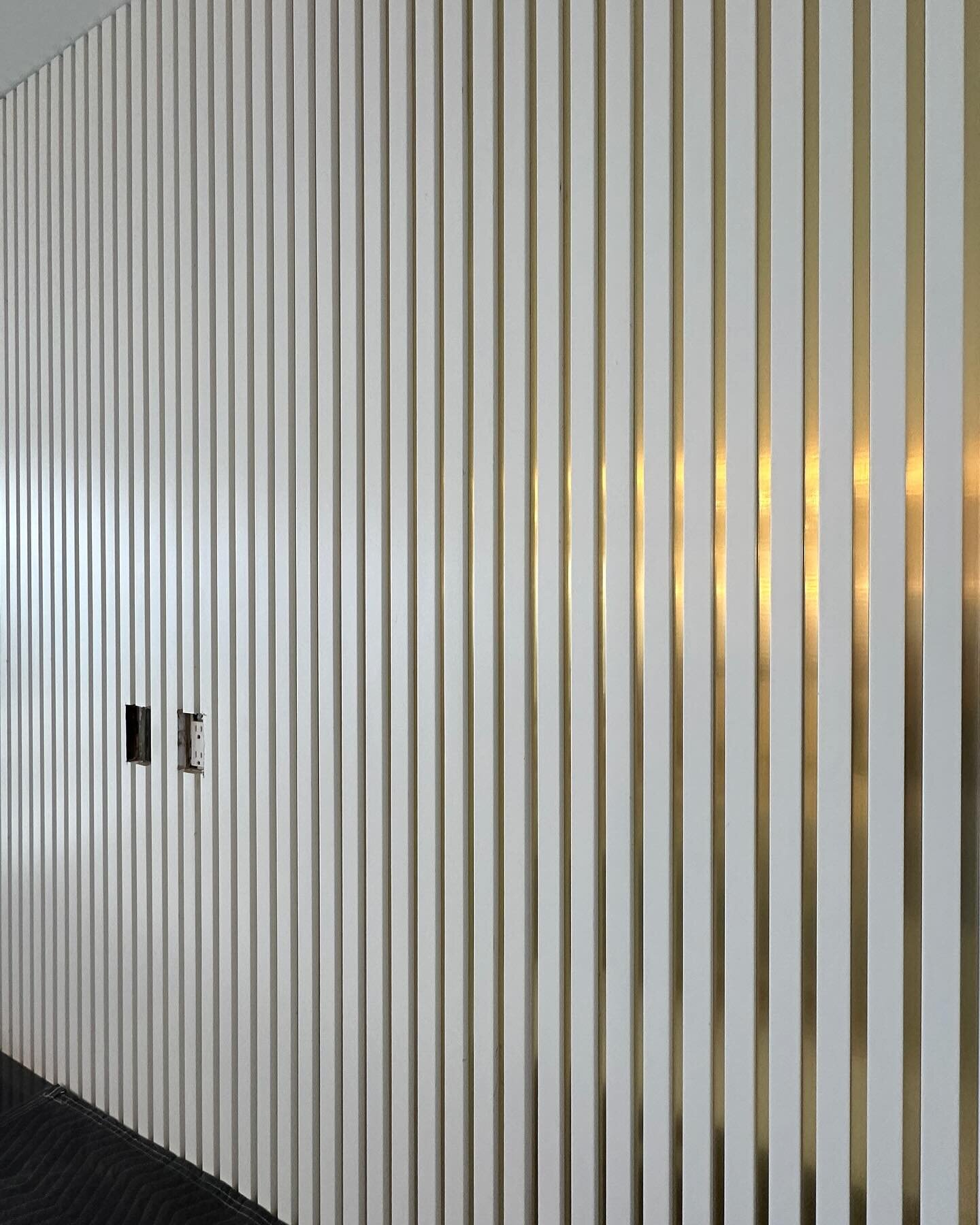 Loving this wall treatment - slat wall painted in gloss white with brushed brass edge banding placed in the groves created a stunning feature wall! Makes me so happy when clients go for something completely custom. #interiordesign #southfloridadesign