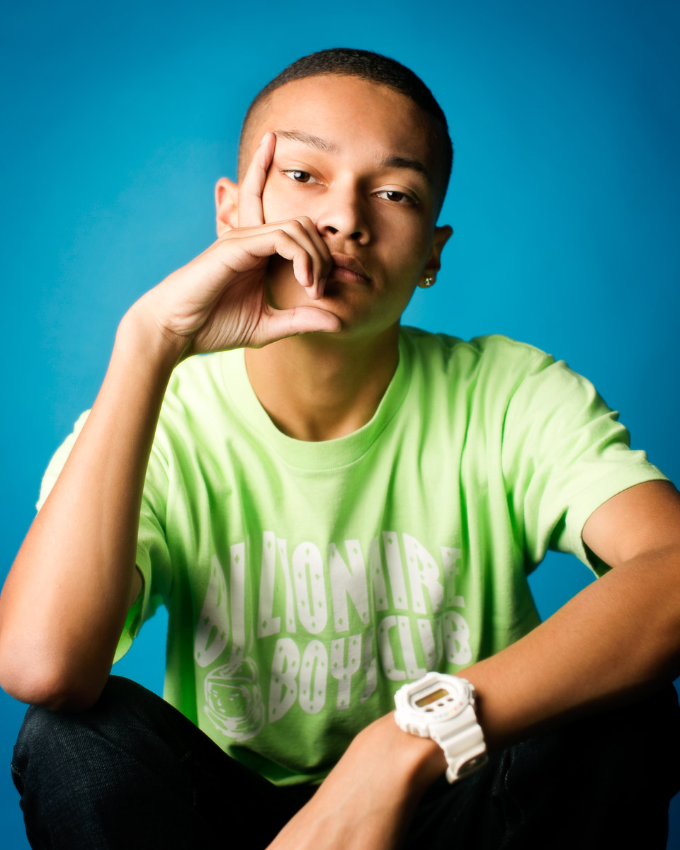  High school senior photography of a young man against a blue background by Campbell Salgado Studio. 