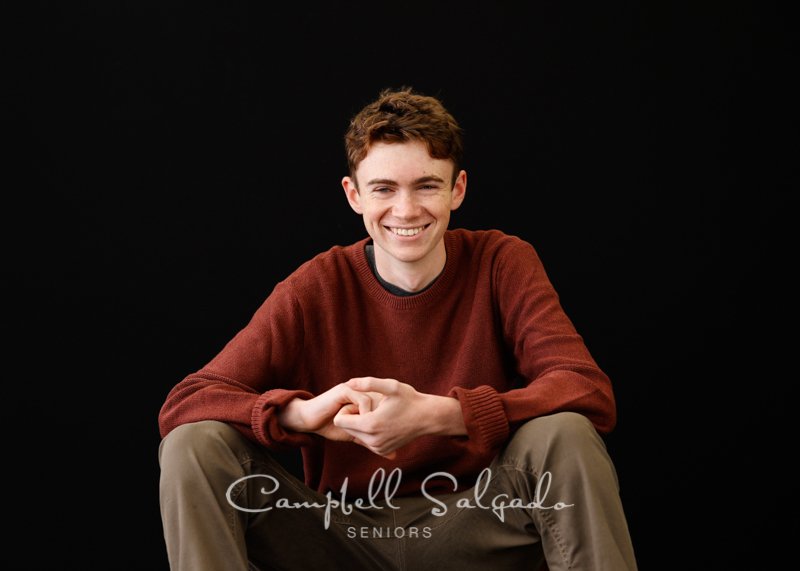  Portrait of young man against a black background by Portland photographers - senior pictures at Campbell Salgado Studio in Portland, Oregon. 