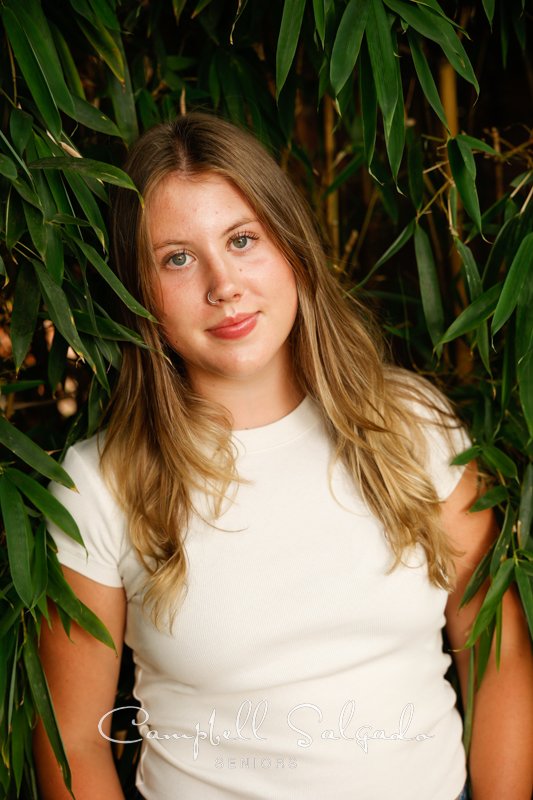 Portrait of young woman against a bamboo background by Portland senior picture photographer Kim Campbell of Campbell Salgado Studio in Portland, Oregon. 