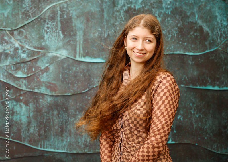  Senior pictures outside of a young woman in front of an ocean weave background by high school senior portrait photographers photographers at Campbell Salgado Studio in Portland, Oregon. 