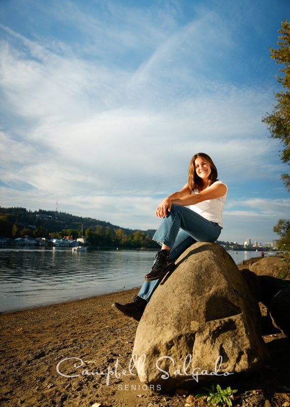  Professional senior portraits of young woman in front of a river background by Portland, Oregon photographers at Campbell Salgado Studio. 