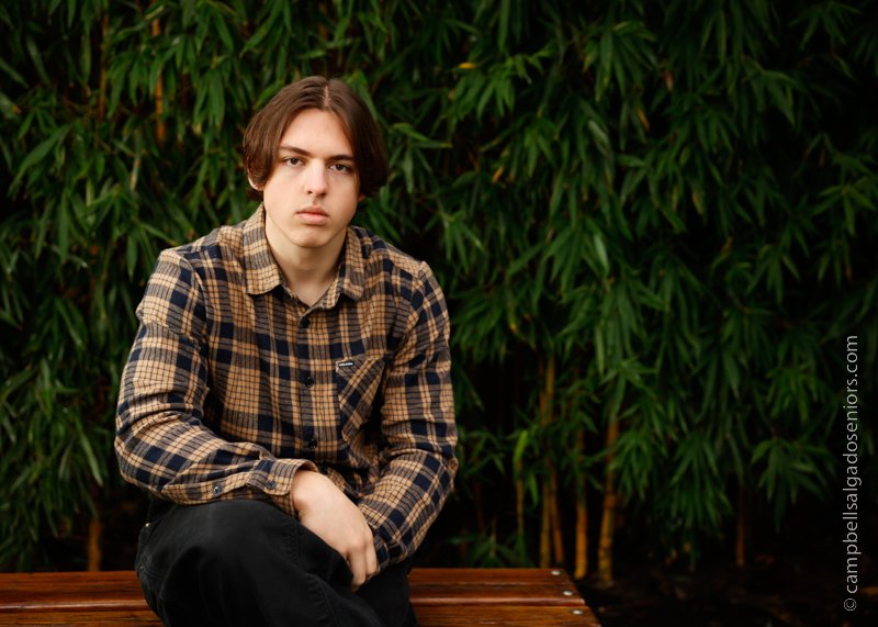  Senior picture of a young man on a bamboo background by high school senior photographers at Campbell Salgado Studio in Portland, Oregon. 