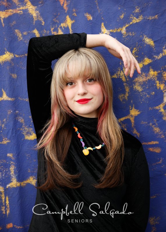  Professional senior portraits of young woman&nbsp;in front of the Frida background by Portland, Oregon photographers at Campbell Salgado Studio. 