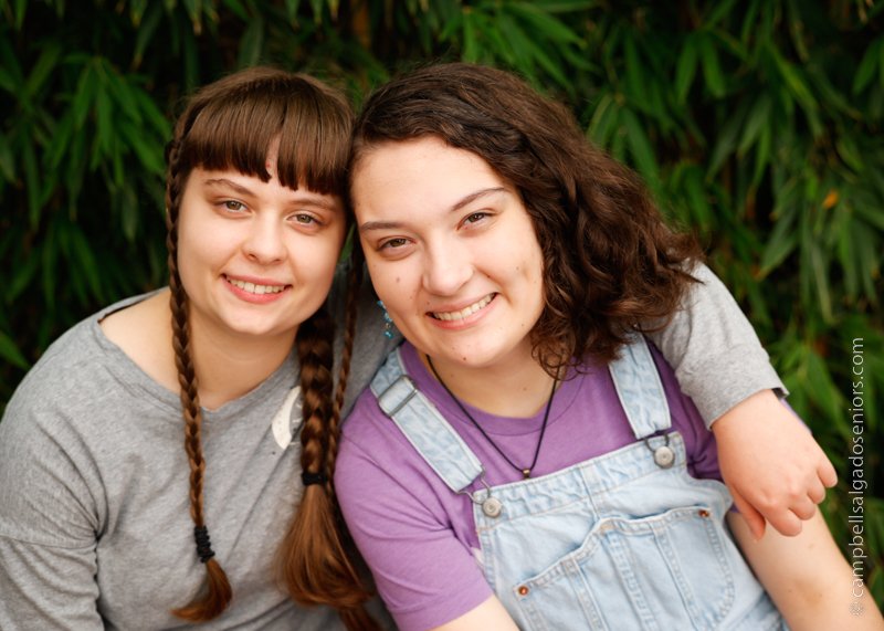   Senior picture of twins on bamboo background by high school senior photographers at Campbell Salgado Studio in Portland, Oregon.  