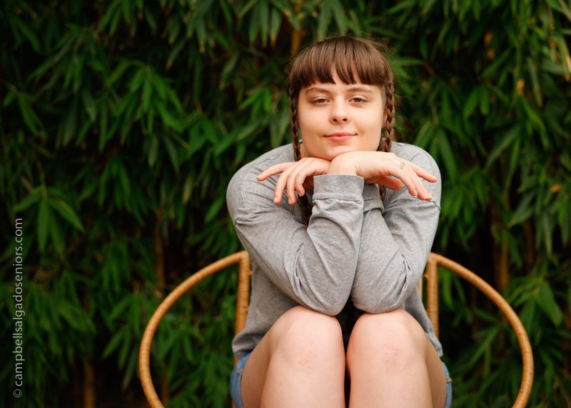   Professional senior portraits of young woman&nbsp;in front of a bamboo background by Portland, Oregon photographers at Campbell Salgado Studio.  